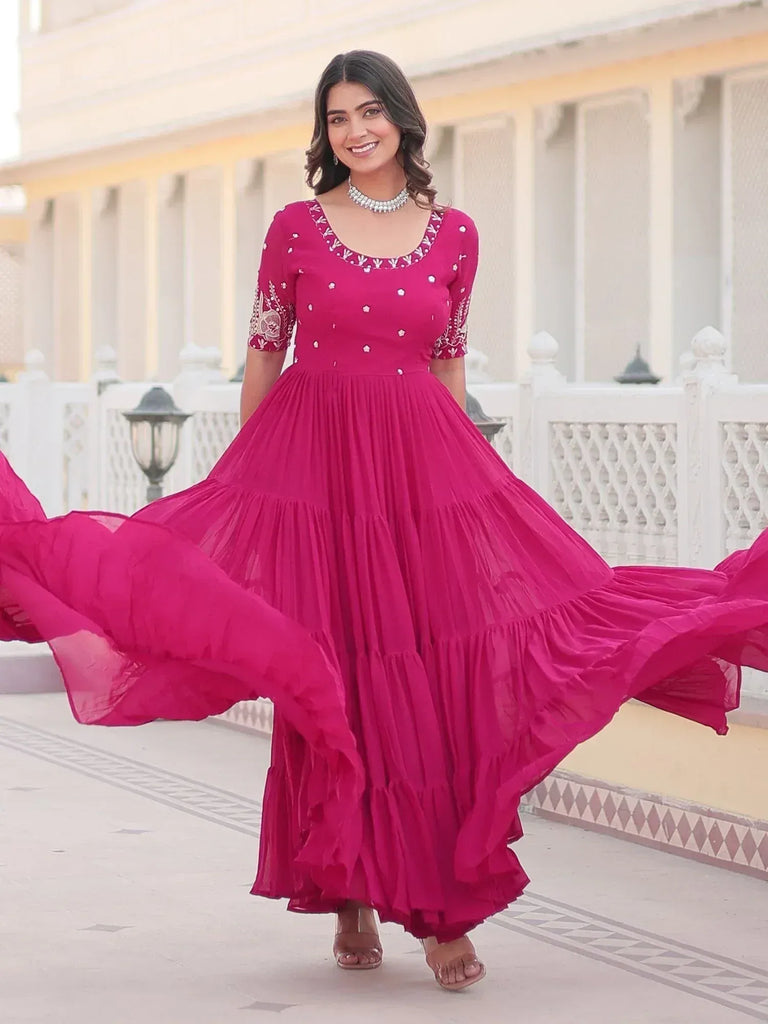 Vibrant pink ethnic gown with embroidery, perfect for Indian occasions and festive wear