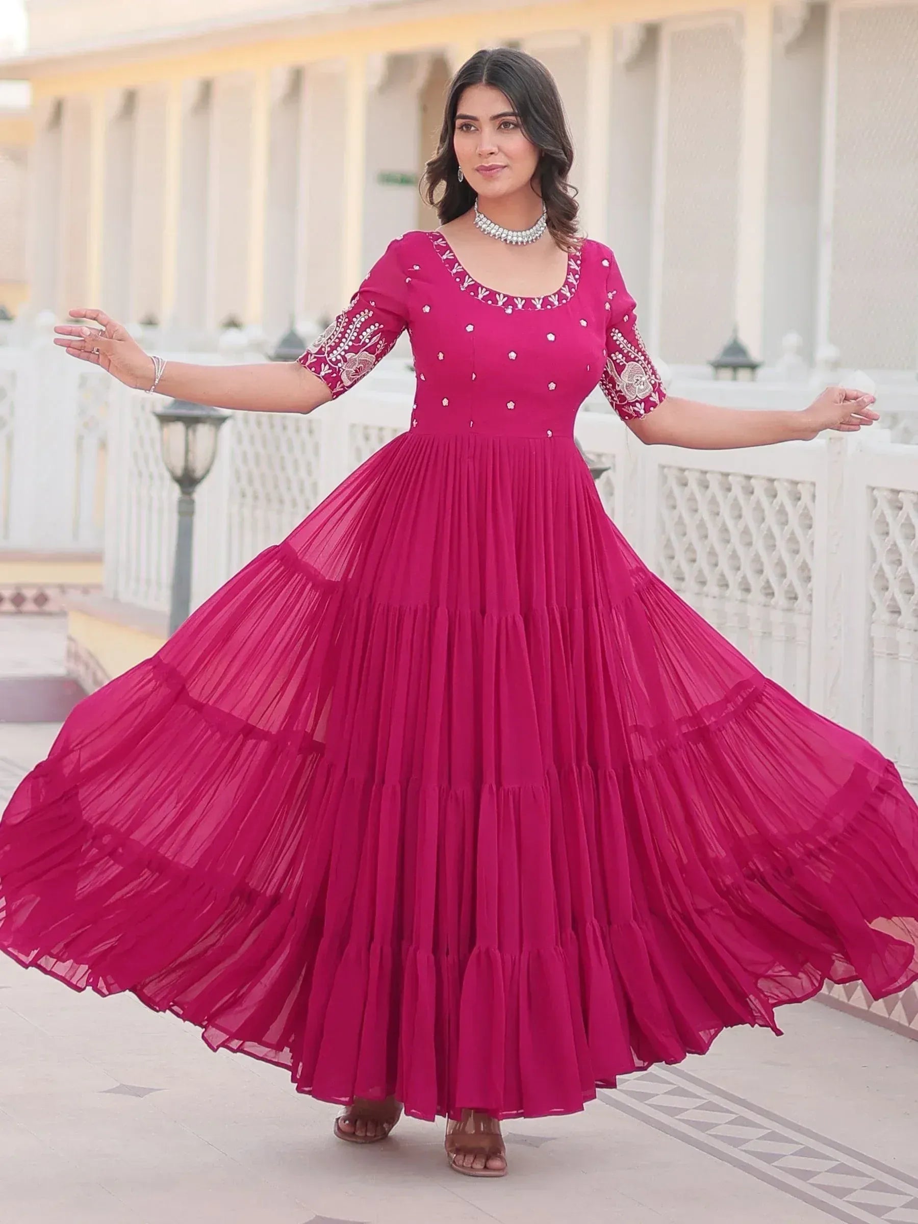 Fuchsia ethnic gown with embroidery and pleated skirt, perfect for Indian festive occasions