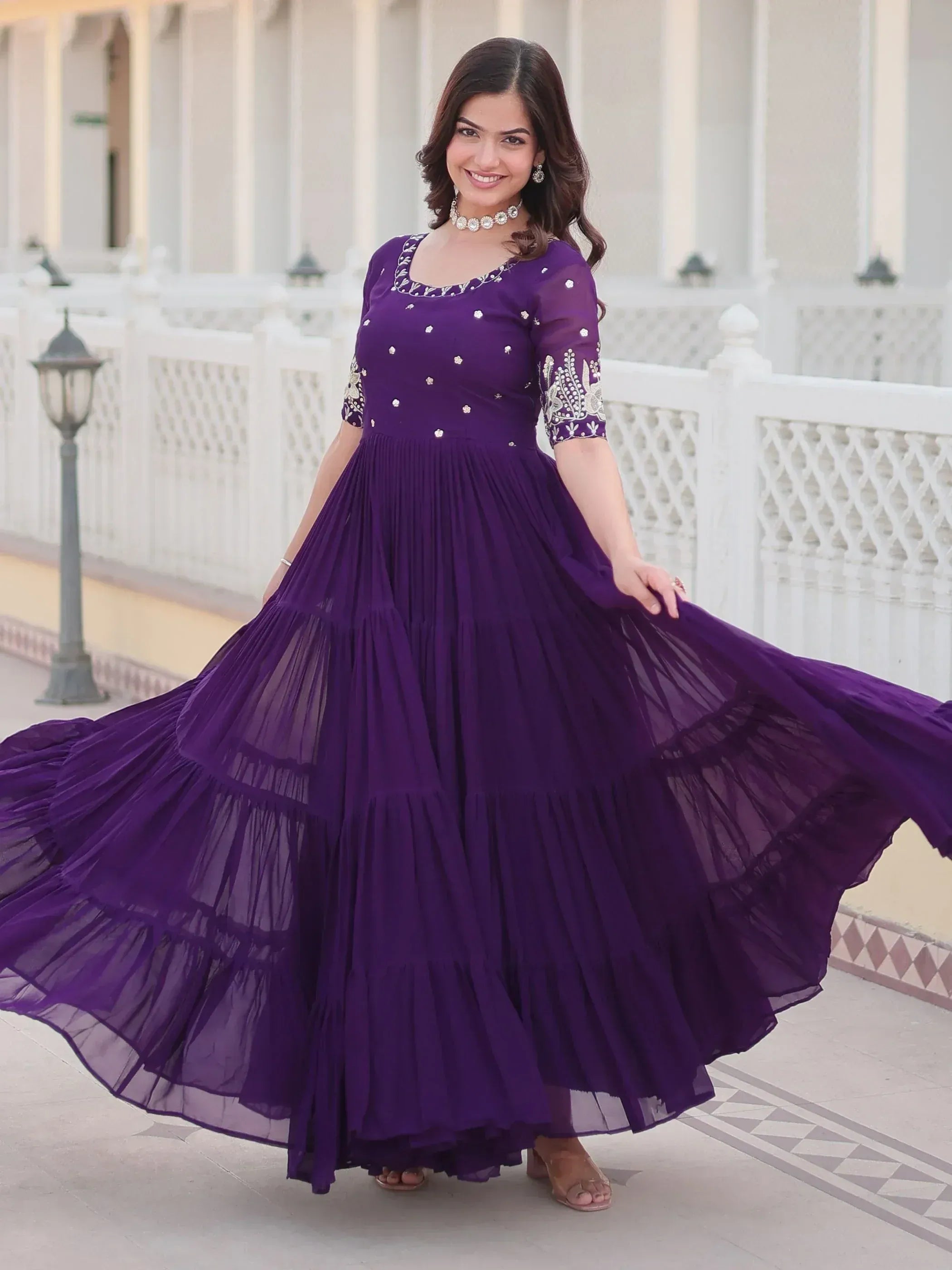 Purple ethnic gown with embroidery and tiered skirt, perfect for Indian occasions