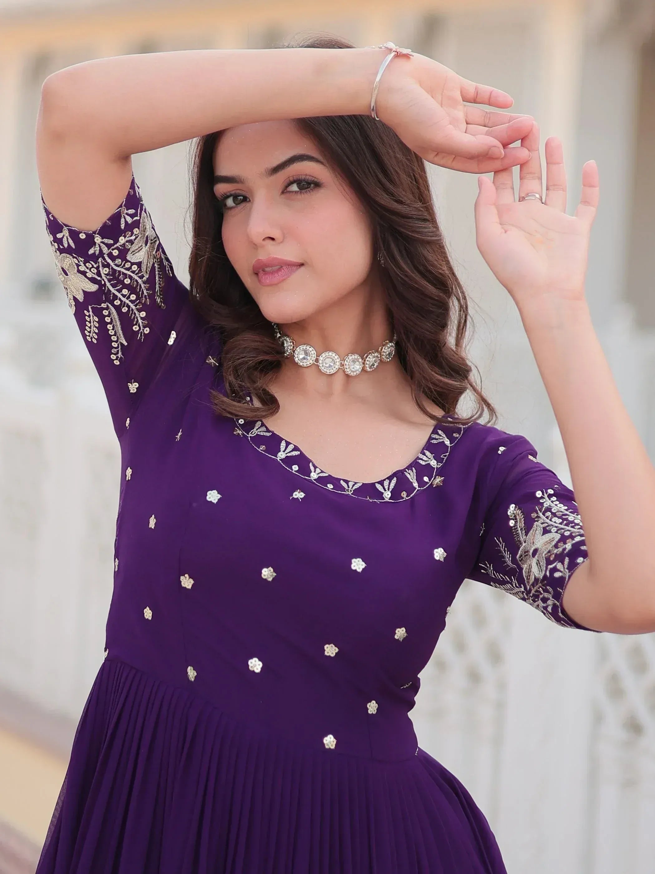 Purple embroidered ethnic gown with floral detailing and pleated skirt, perfect for Indian occasions
