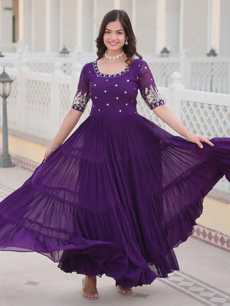 Purple ethnic gown with floral embroidery and pleated skirt, perfect for Indian festive occasions