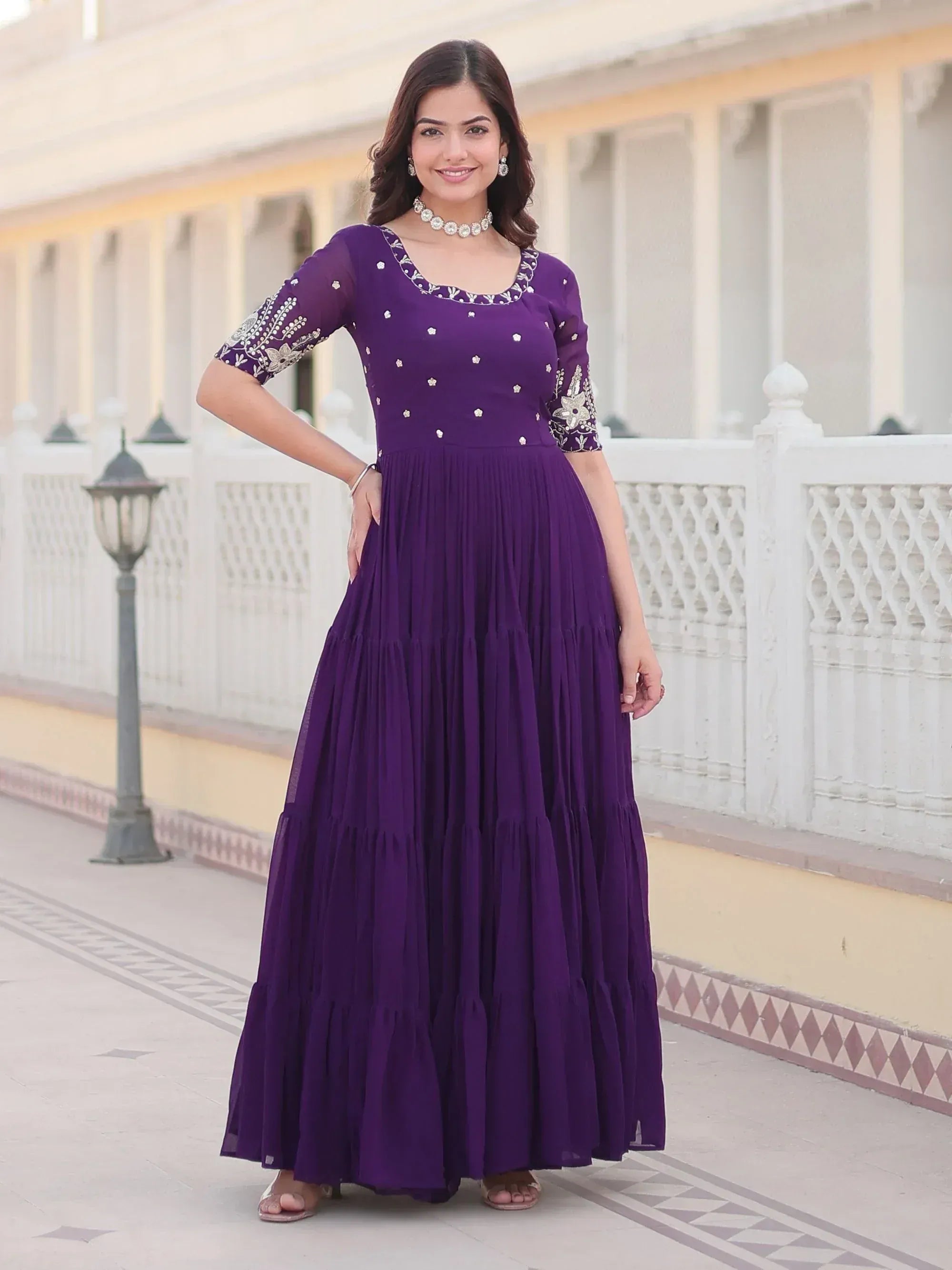 Purple embroidered ethnic gown with pleated skirt, perfect for Indian festive wear and occasions.