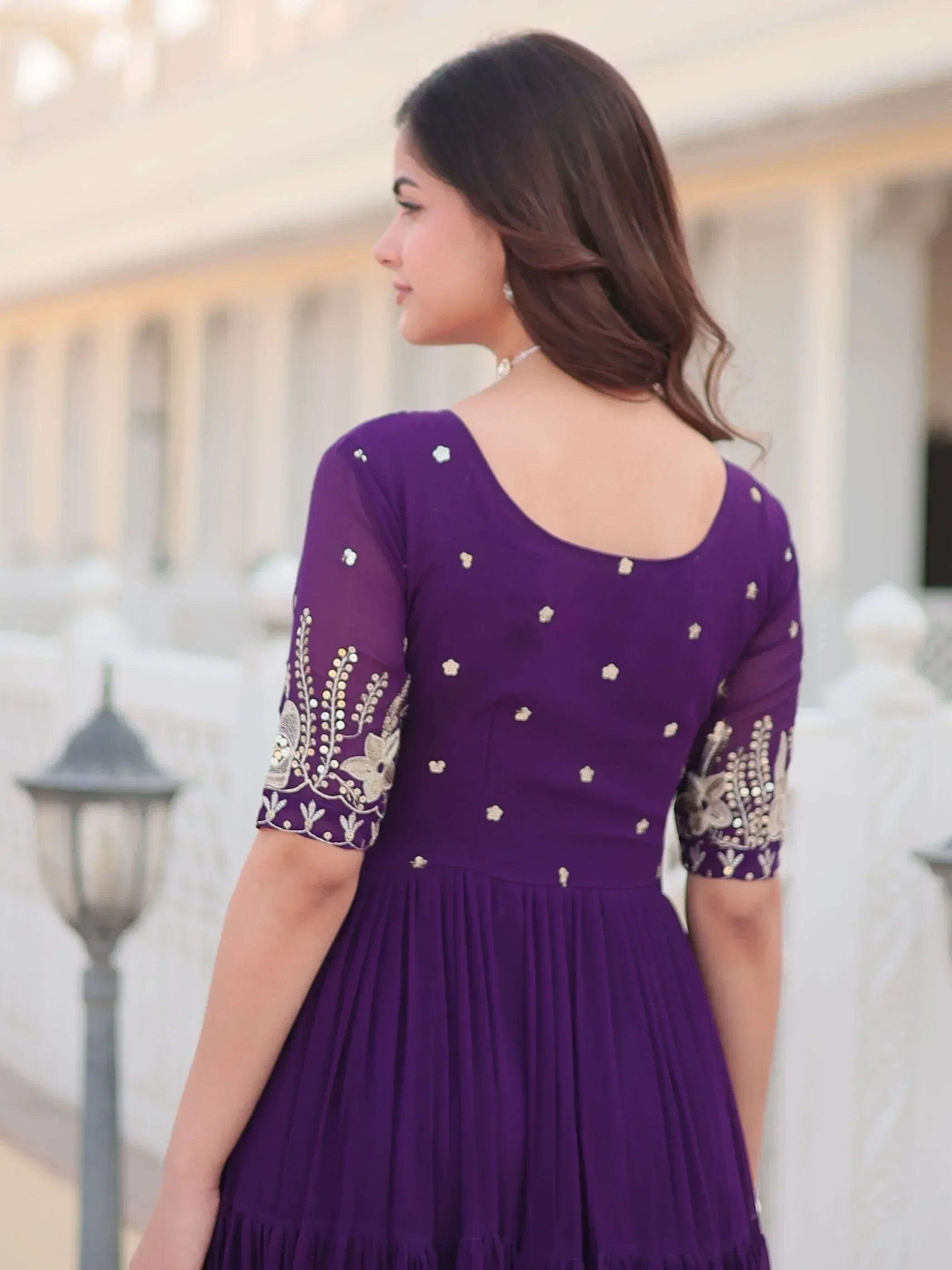 Purple ethnic gown with gold embroidery, pleated skirt, and sheer sleeves for Indian wear