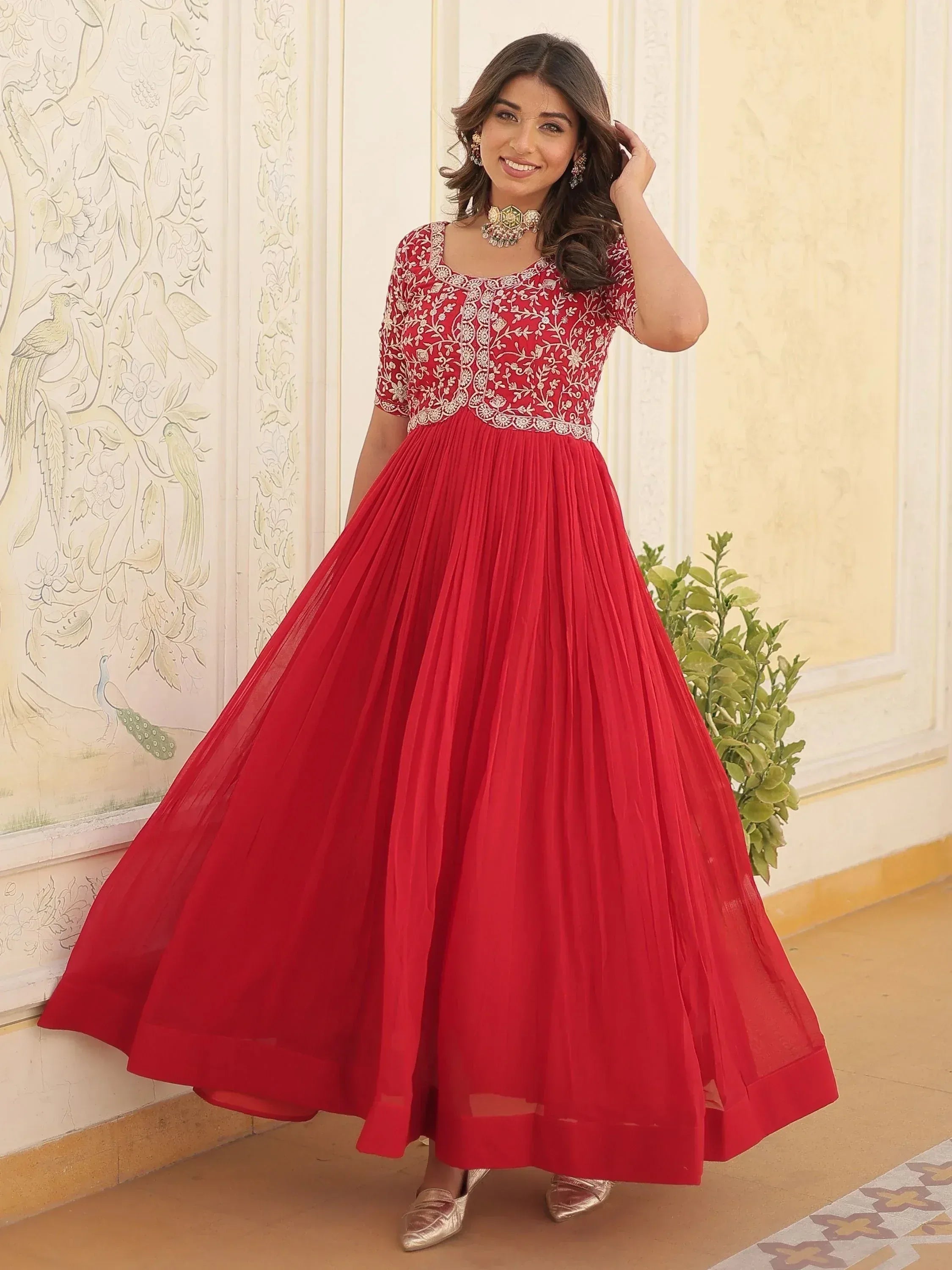 Red embroidered ethnic gown with pleated skirt, perfect for Indian weddings and festive occasions