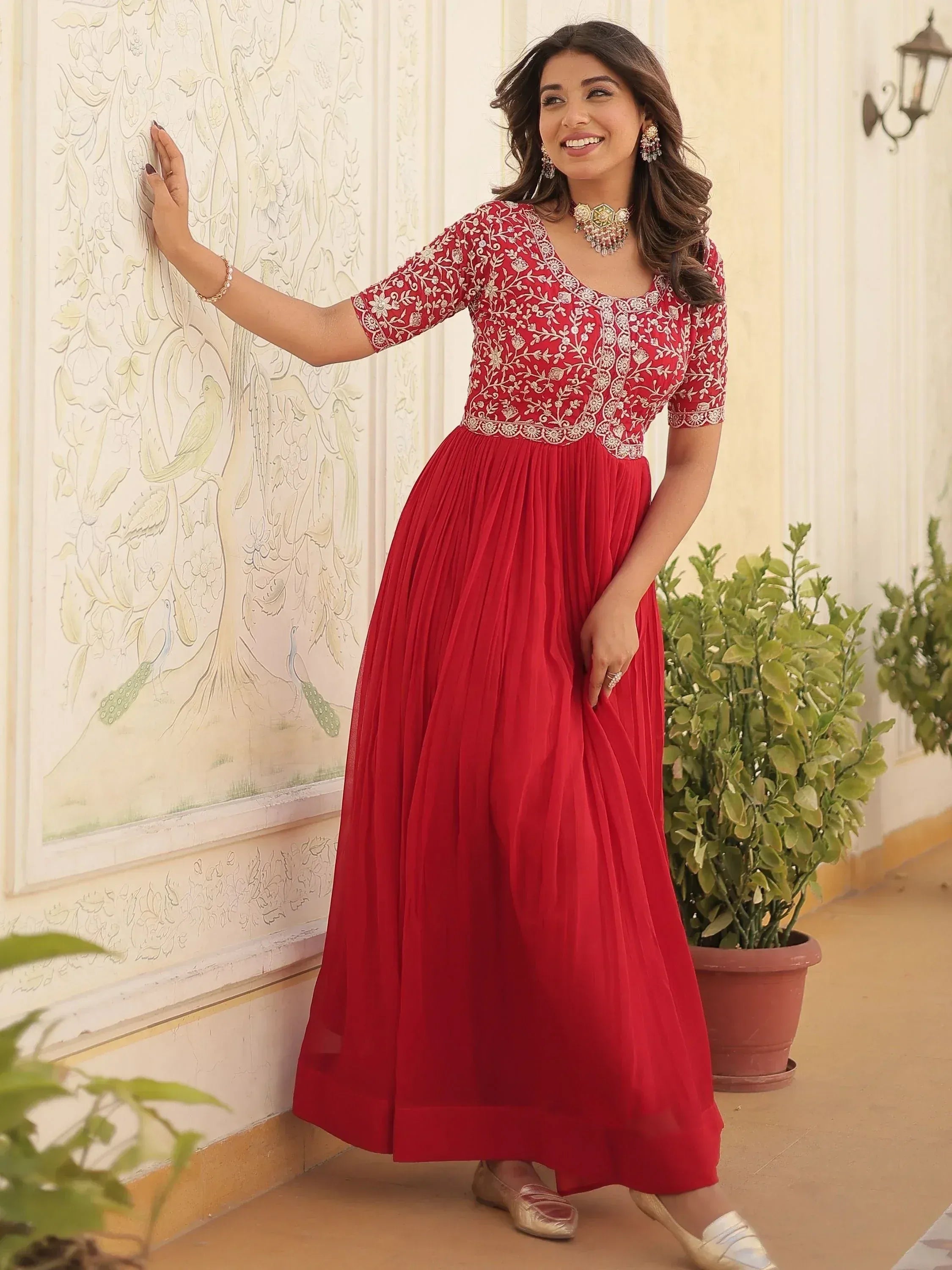 Red ethnic gown with gold embroidery, perfect for Indian occasions and festive wear.