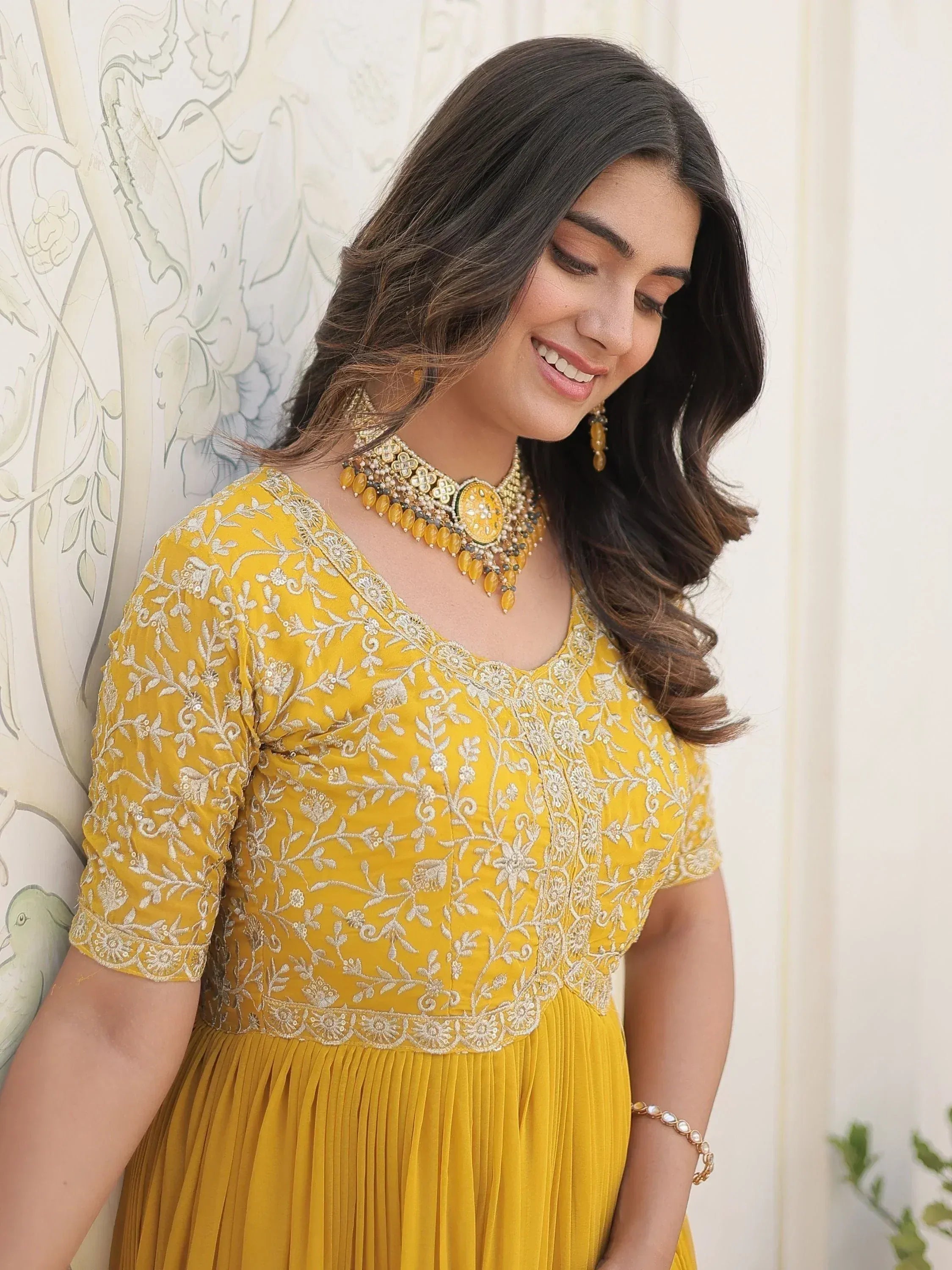 Yellow embroidered ethnic gown with floral detailing, perfect for Indian occasions and festive wear.