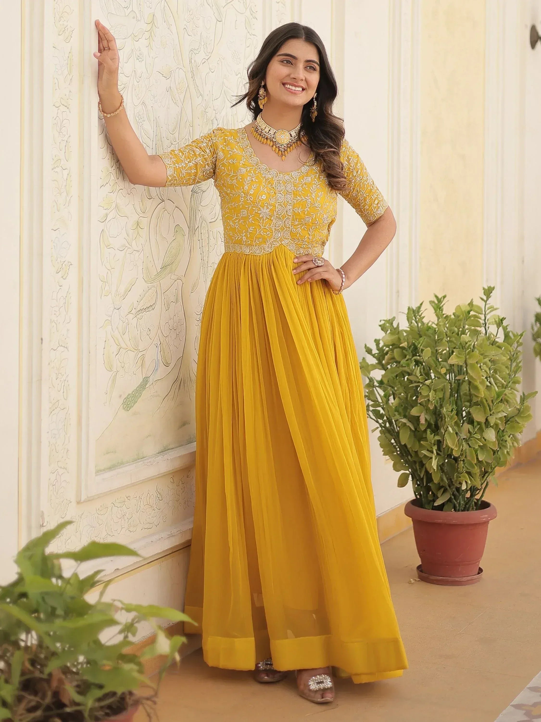 Yellow embroidered ethnic gown with pleated skirt, perfect for Indian occasions and festive wear