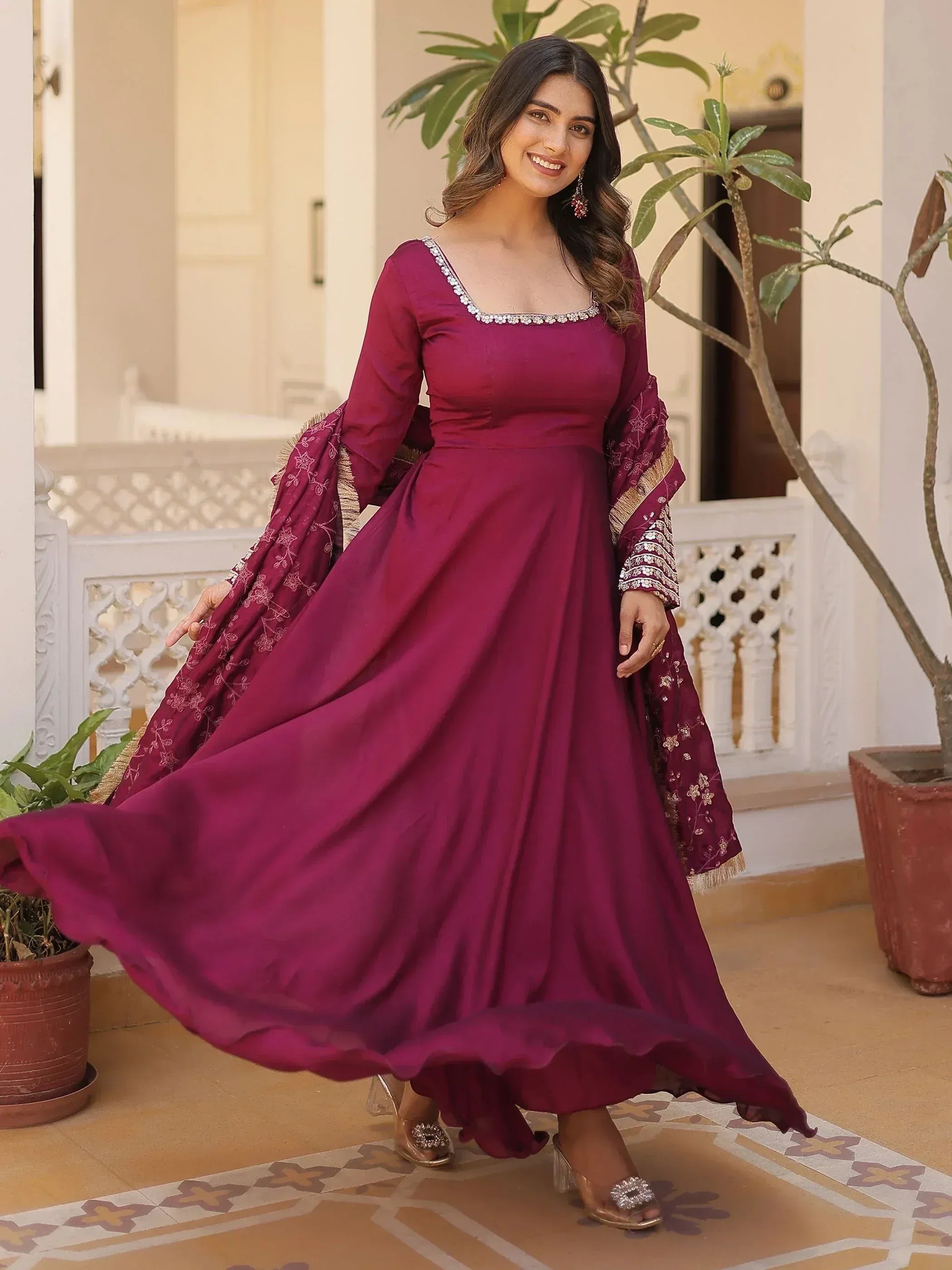 Elegant maroon ethnic gown with embroidered dupatta, perfect for Indian celebrations and festive occasions.