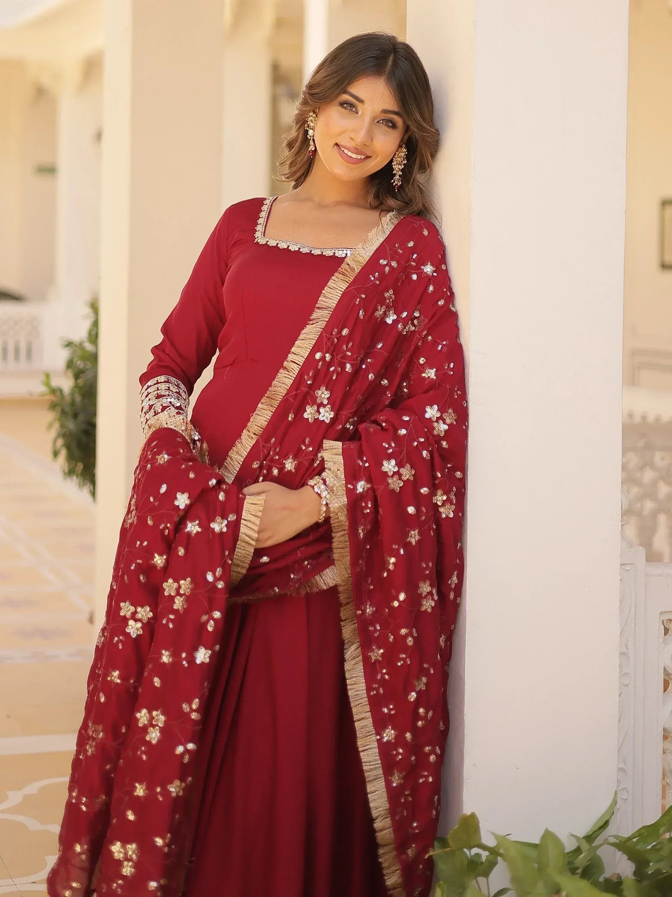 Maroon ethnic salwar kameez with gold floral embroidery and dupatta, perfect for Indian occasions