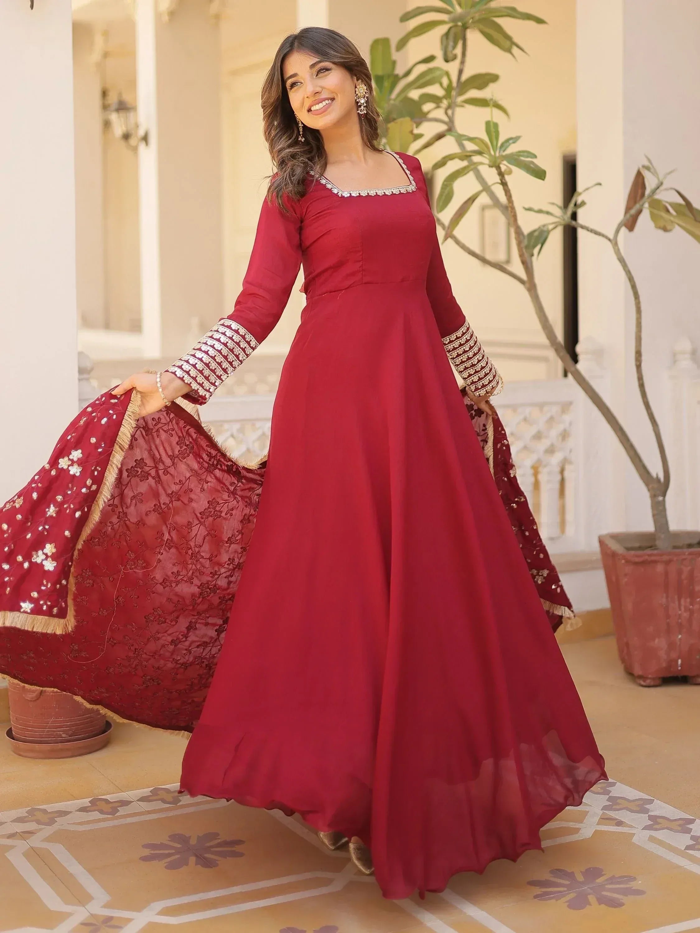 Woman in maroon ethnic gown with embroidered dupatta, perfect for Indian occasions and weddings