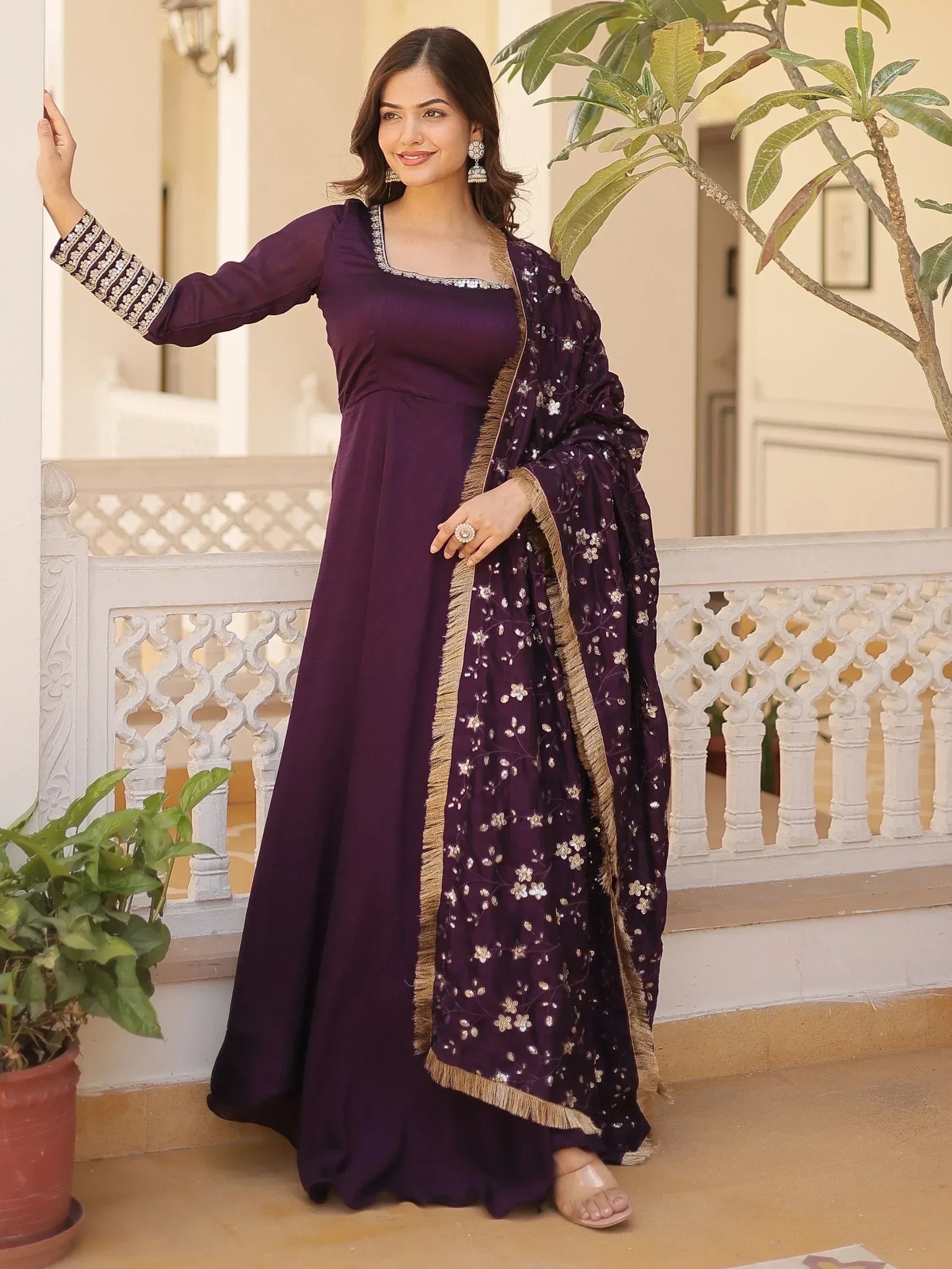 Purple ethnic gown with floral embroidery and gold trim, perfect for Indian occasions