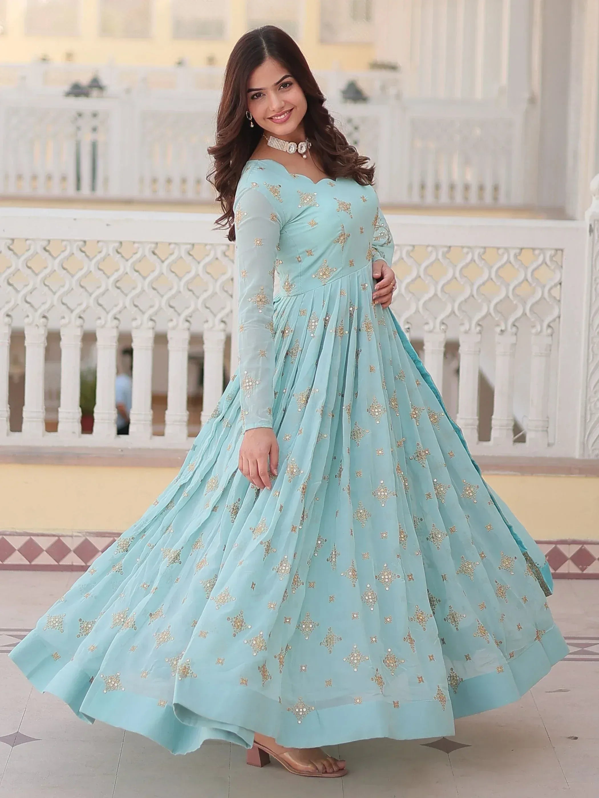 Mint blue ethnic gown with gold embroidery, perfect for Indian occasions and festive wear.