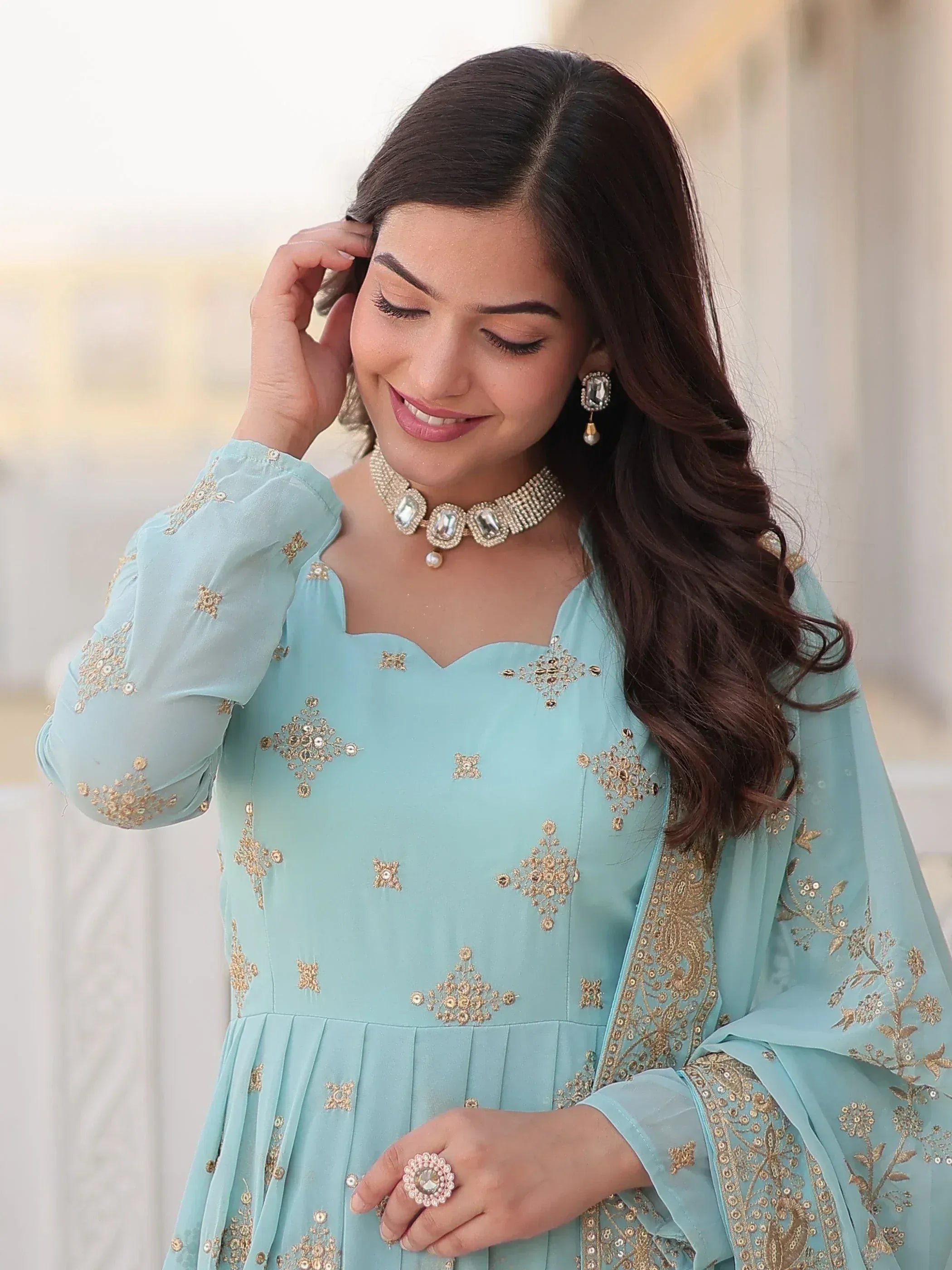 Light blue embroidered ethnic gown with gold detailing, perfect for Indian occasions and festive wear.