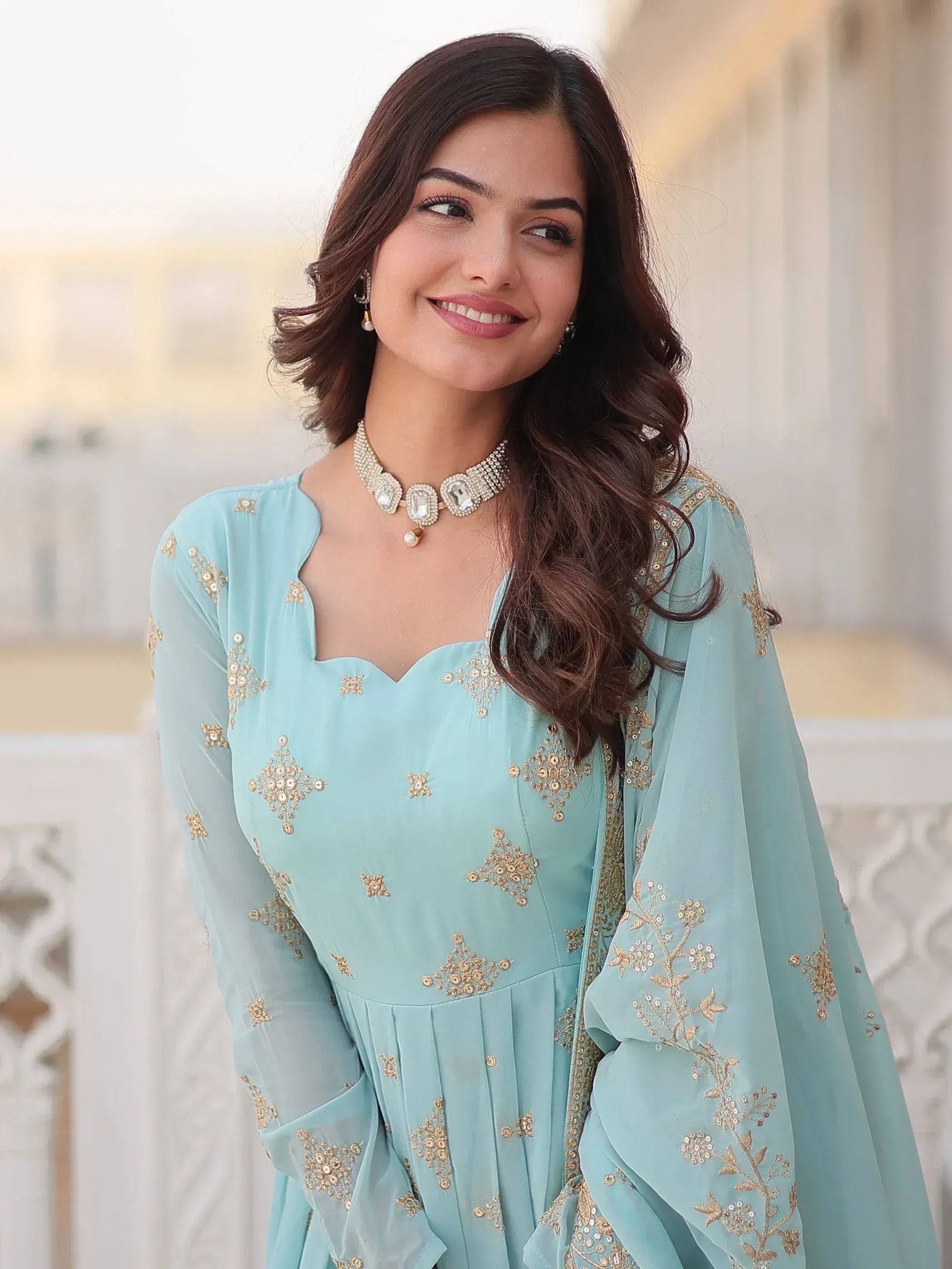 Light blue embroidered ethnic gown with gold detailing, perfect for Indian occasions and festive wear.