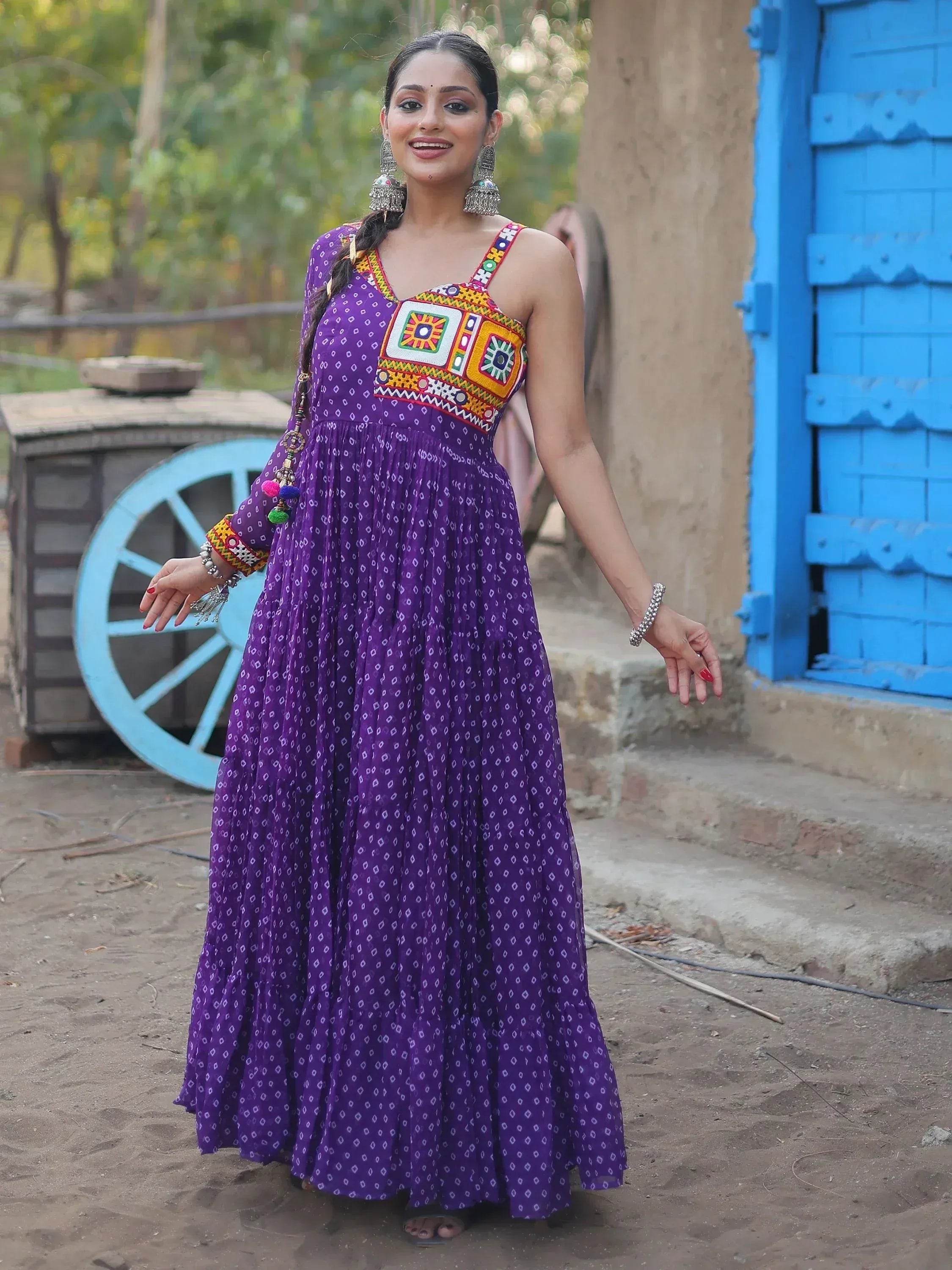 Purple ethnic gown with colorful embroidery, perfect for Indian festive wear and traditional occasions.
