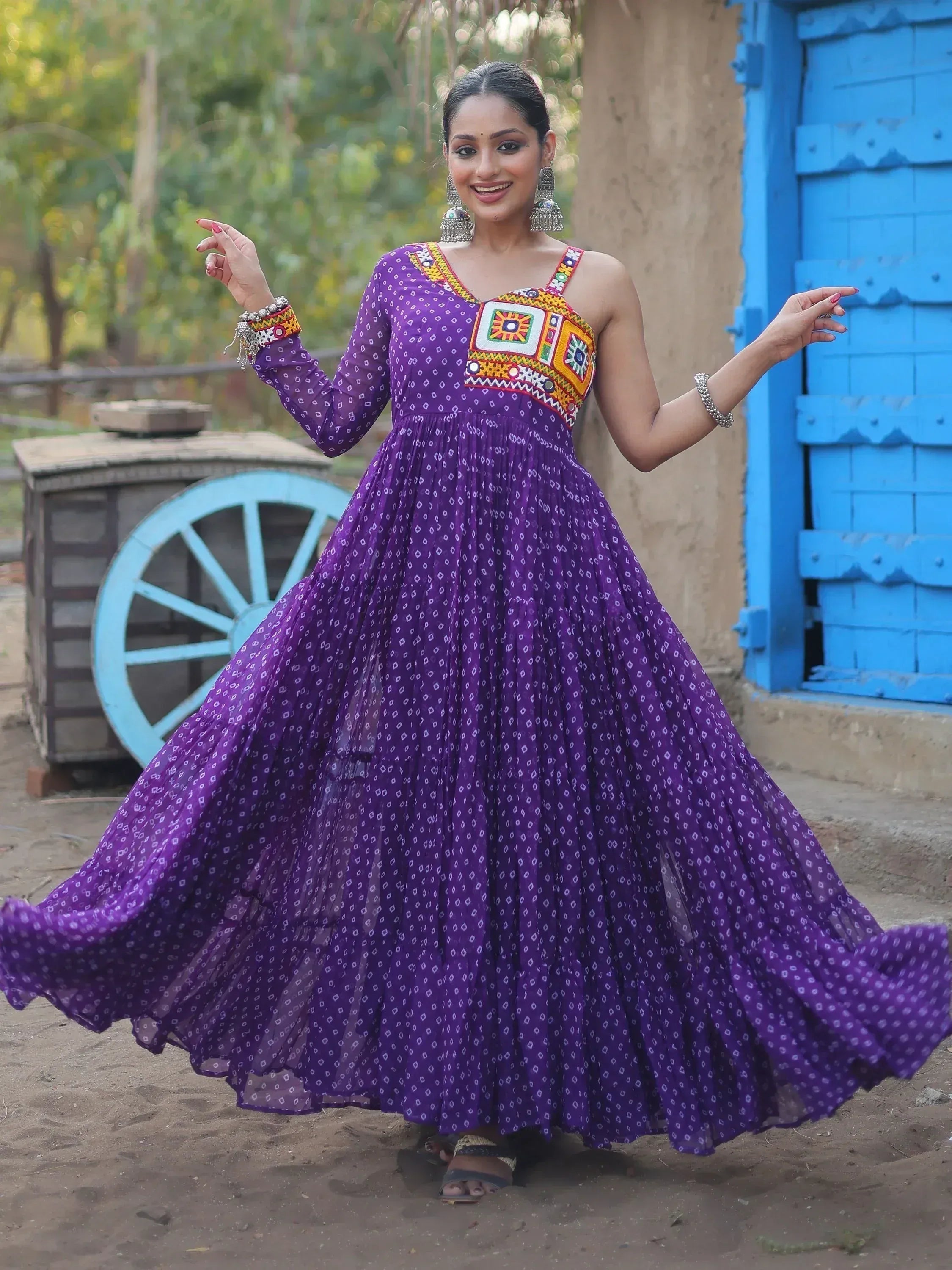 Purple ethnic gown with mirror work, perfect for Indian festivals and events. Stylish designer wear.