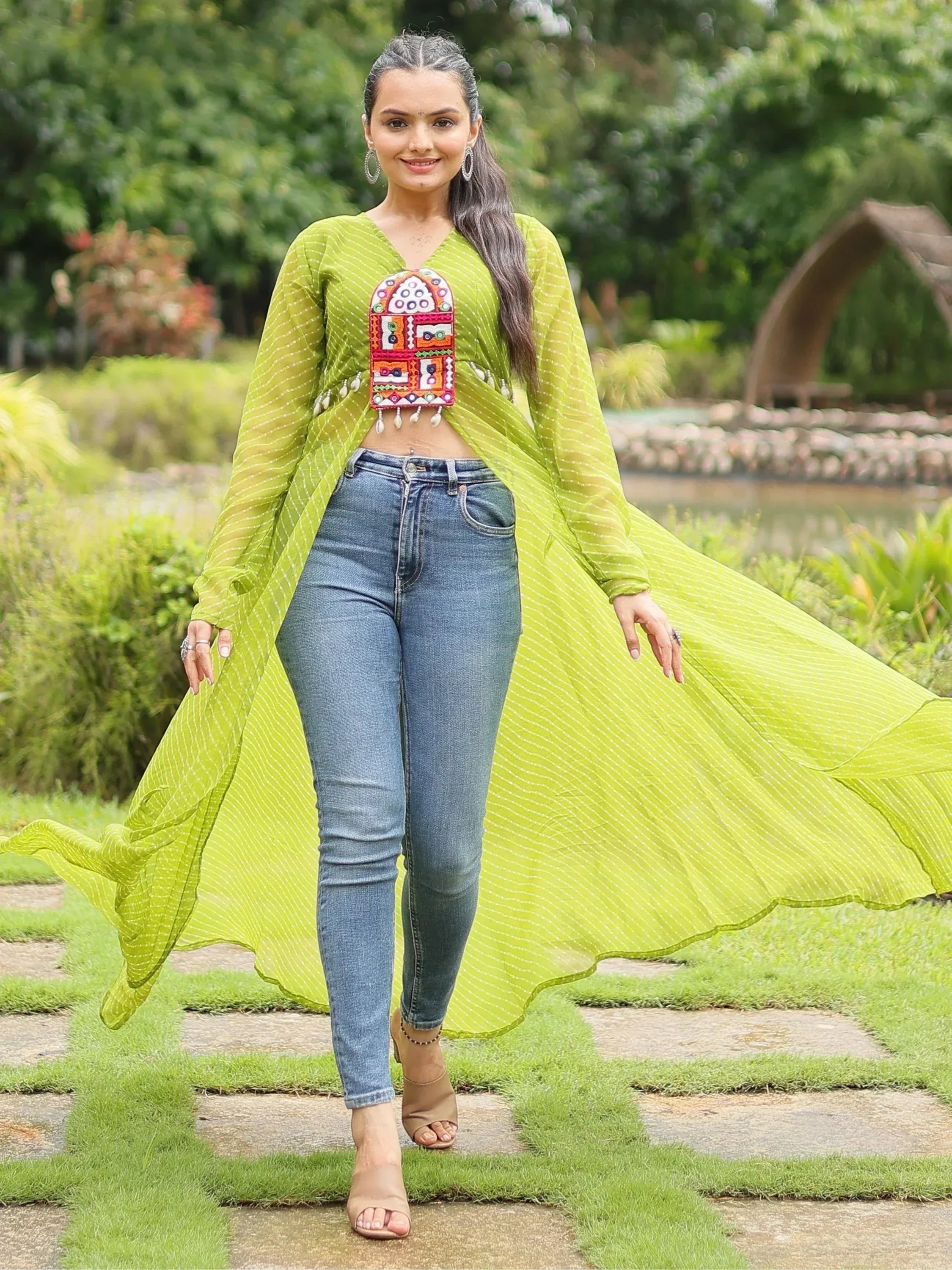 Lime green ethnic crop top with mirror work, paired with jeans, perfect for fusion fashion looks.