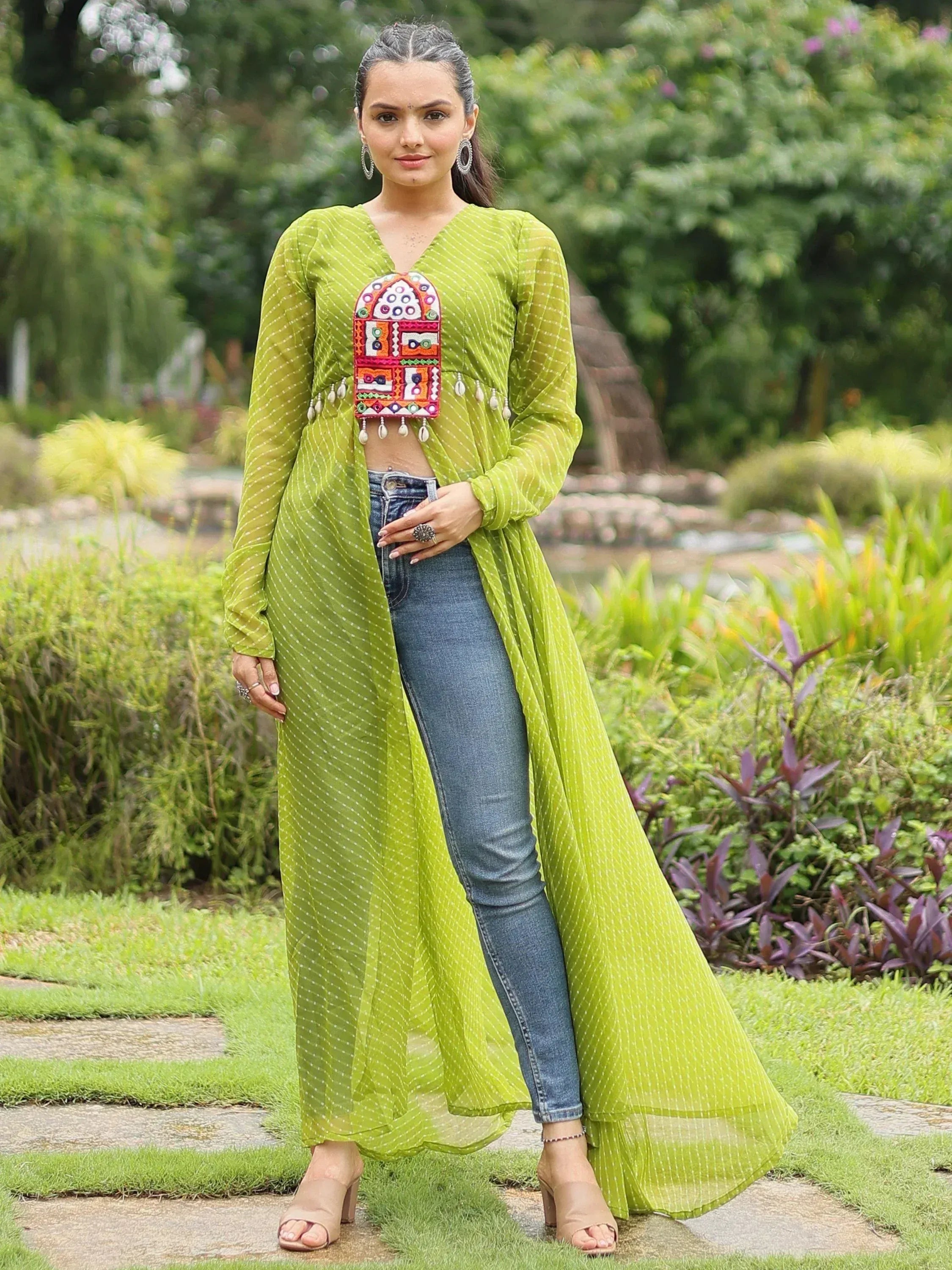 Green dotted ethnic kurta with colorful embroidery, paired with jeans, for a fusion Indian look