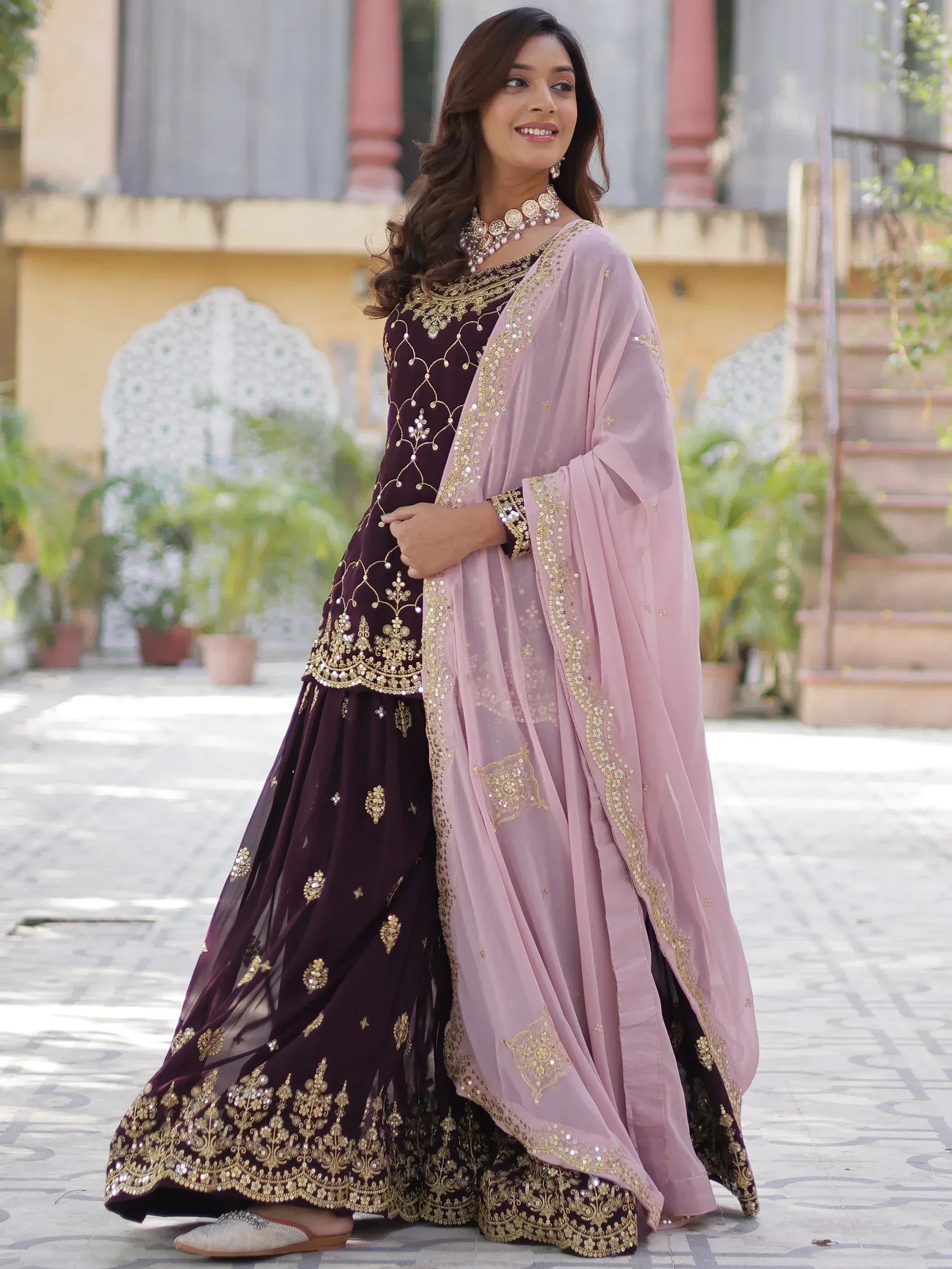 Elegant maroon and pink designer lehenga choli with gold embroidery, perfect for Indian ethnic wear occasions.