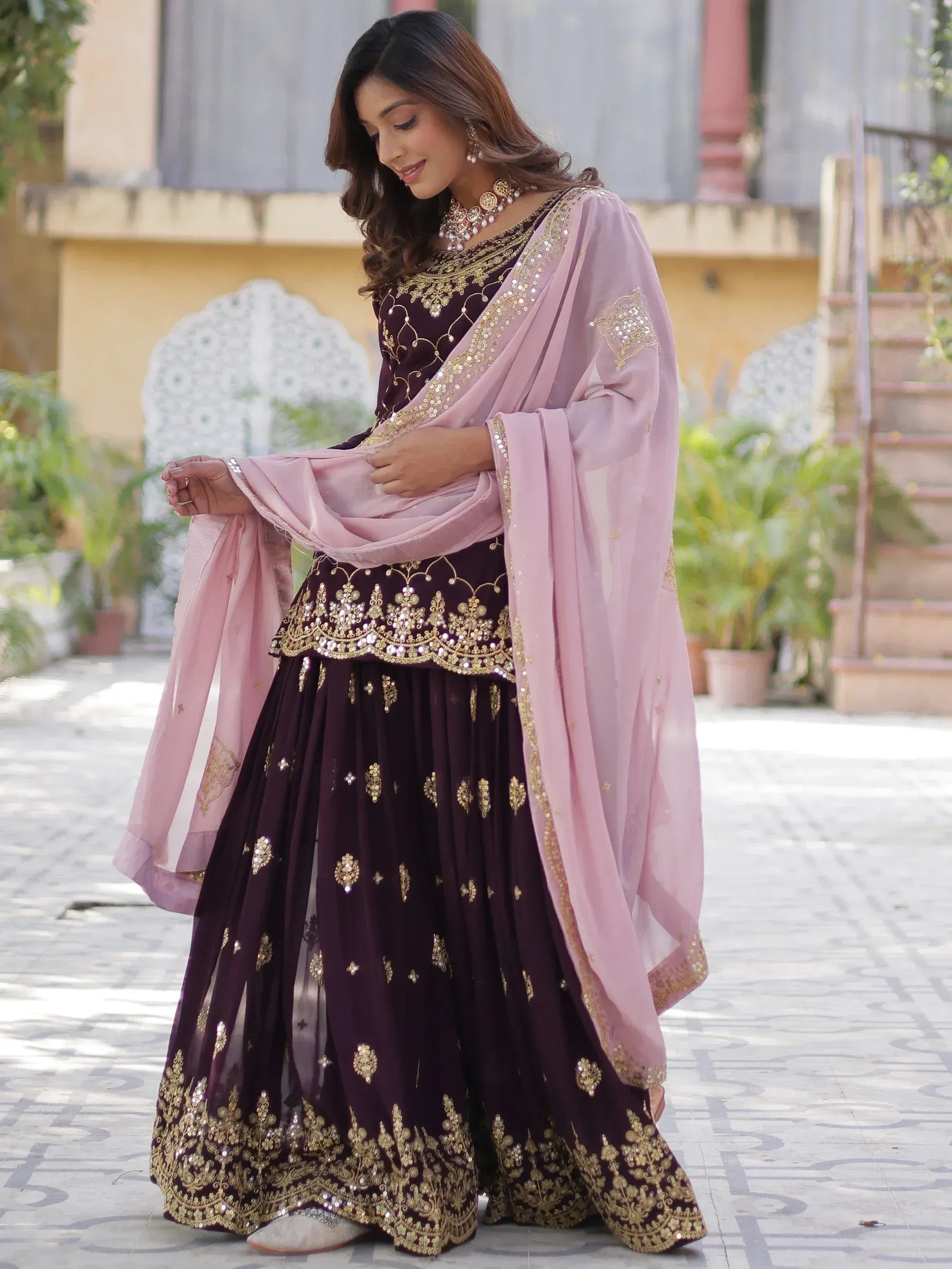 Elegant maroon lehenga choli with gold embroidery and pink dupatta, perfect for Indian ethnic occasions