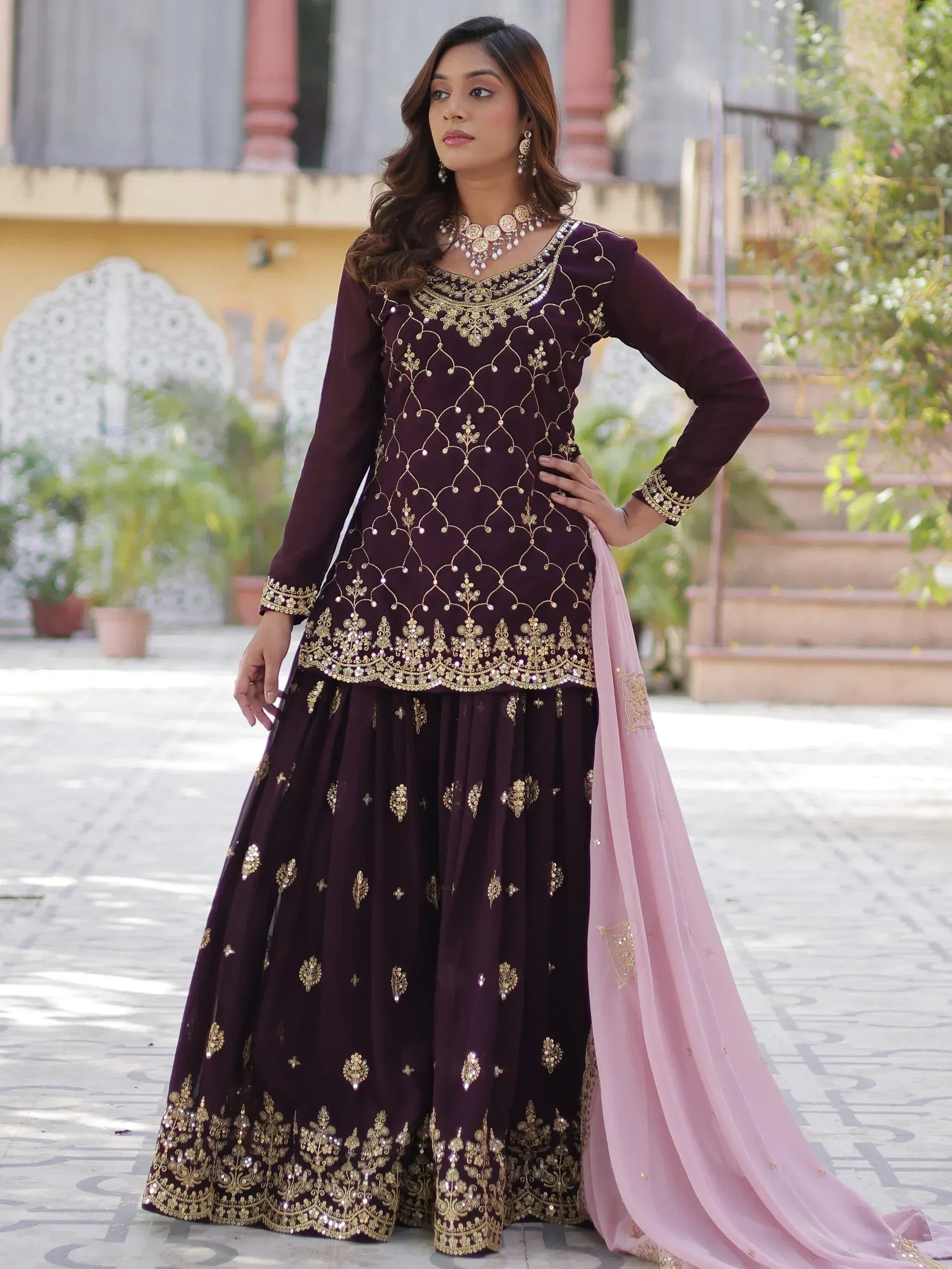 Elegant maroon Indian anarkali suit with gold embroidery and pink dupatta, perfect for weddings and festivals.