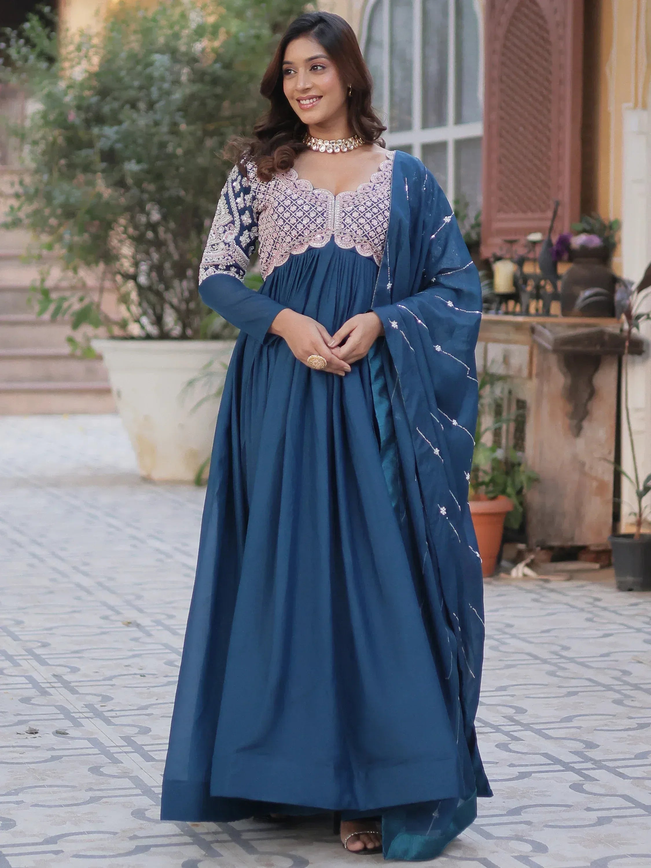 Woman in blue embroidered ethnic gown with scalloped neckline and matching dupatta, perfect for Indian occasions