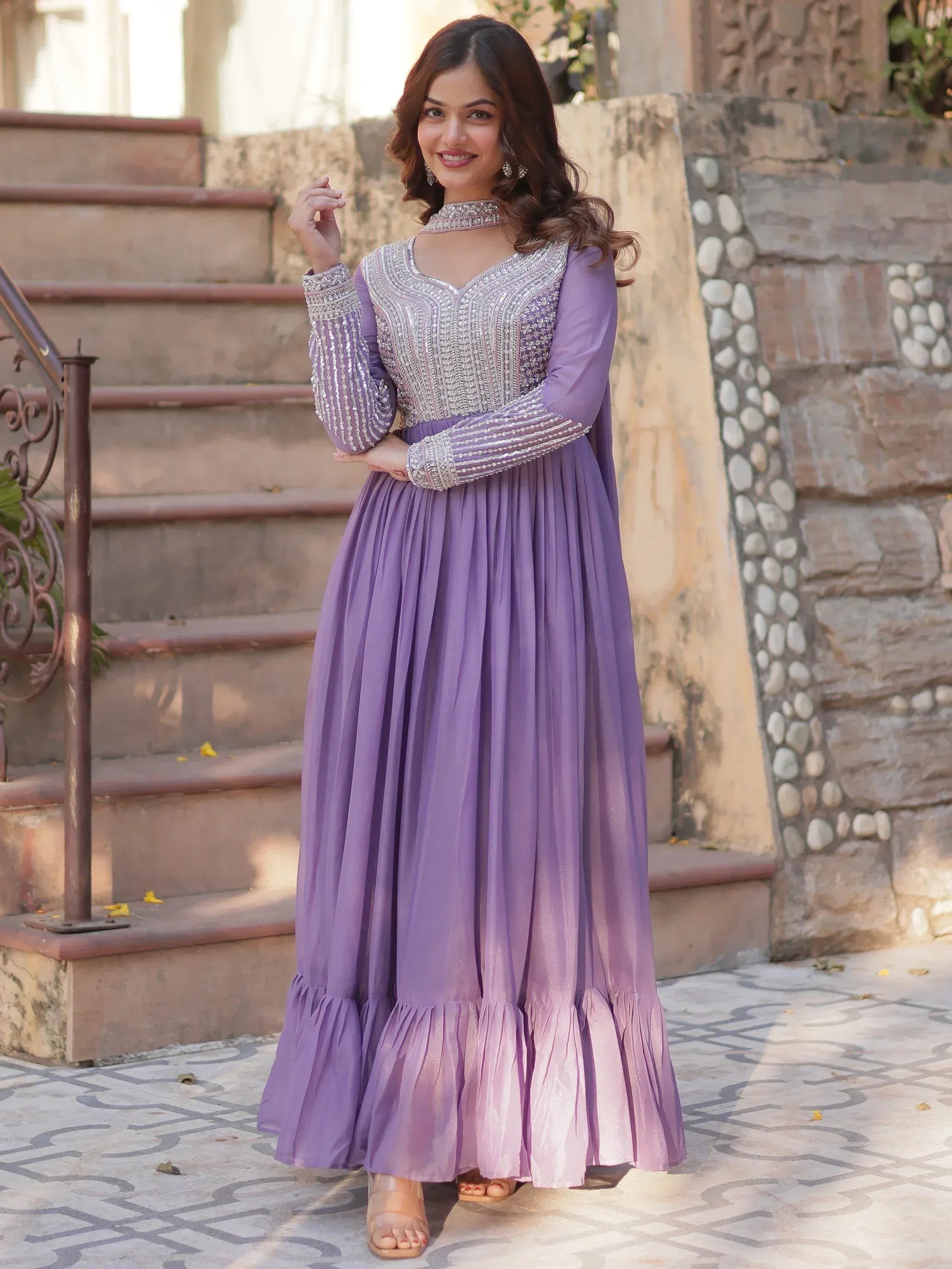 Lavender ethnic gown with silver embroidery, pleated skirt, and choker neckline for festive occasions