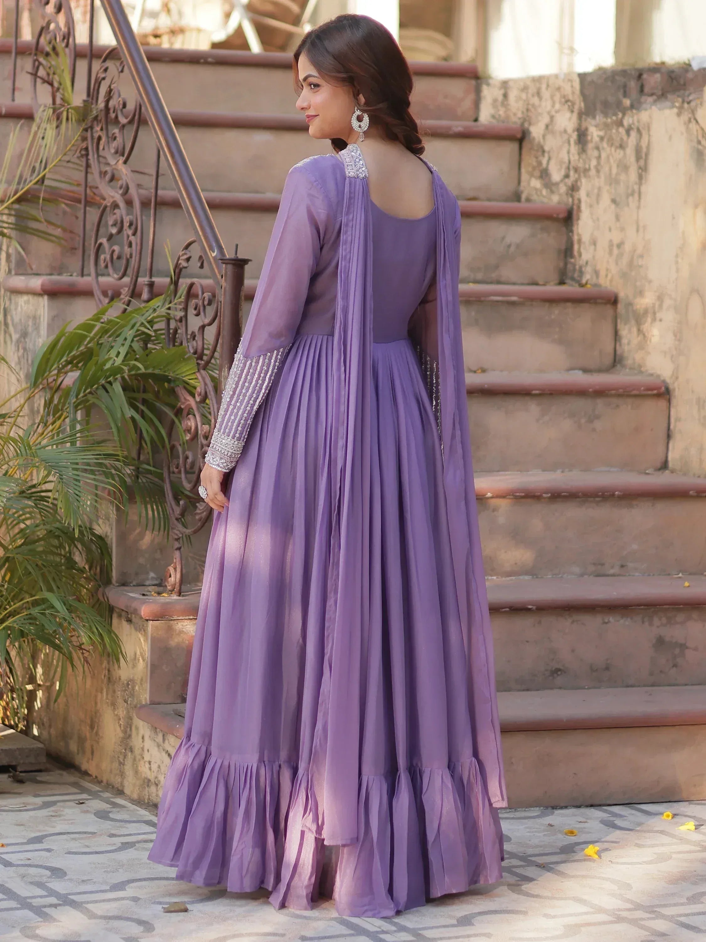 Purple designer anarkali gown with silver embroidery, pleated skirt, and sheer sleeves for ethnic occasions