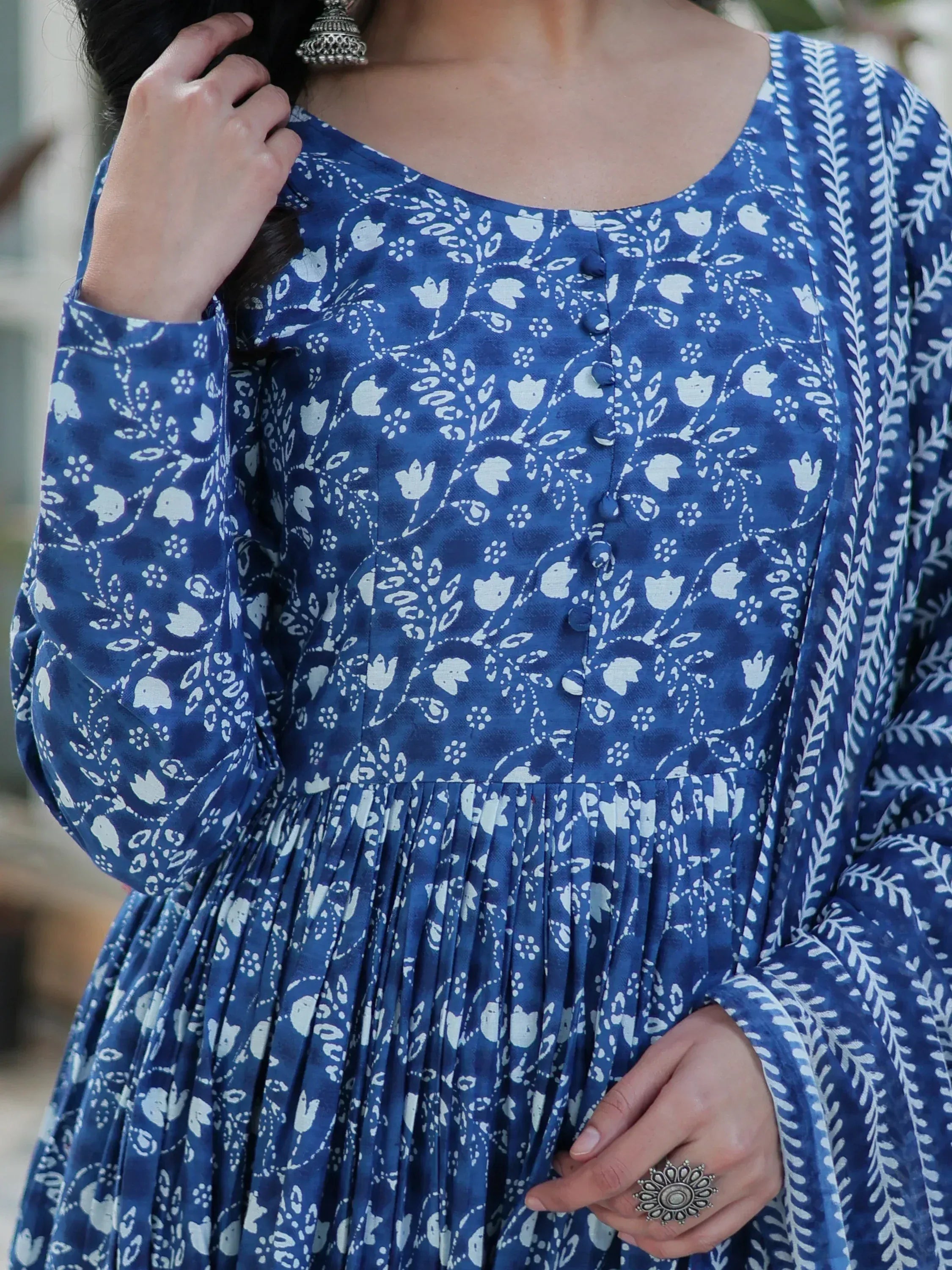 Blue floral printed ethnic kurta with button front and pleated hem, styled with silver jewelry