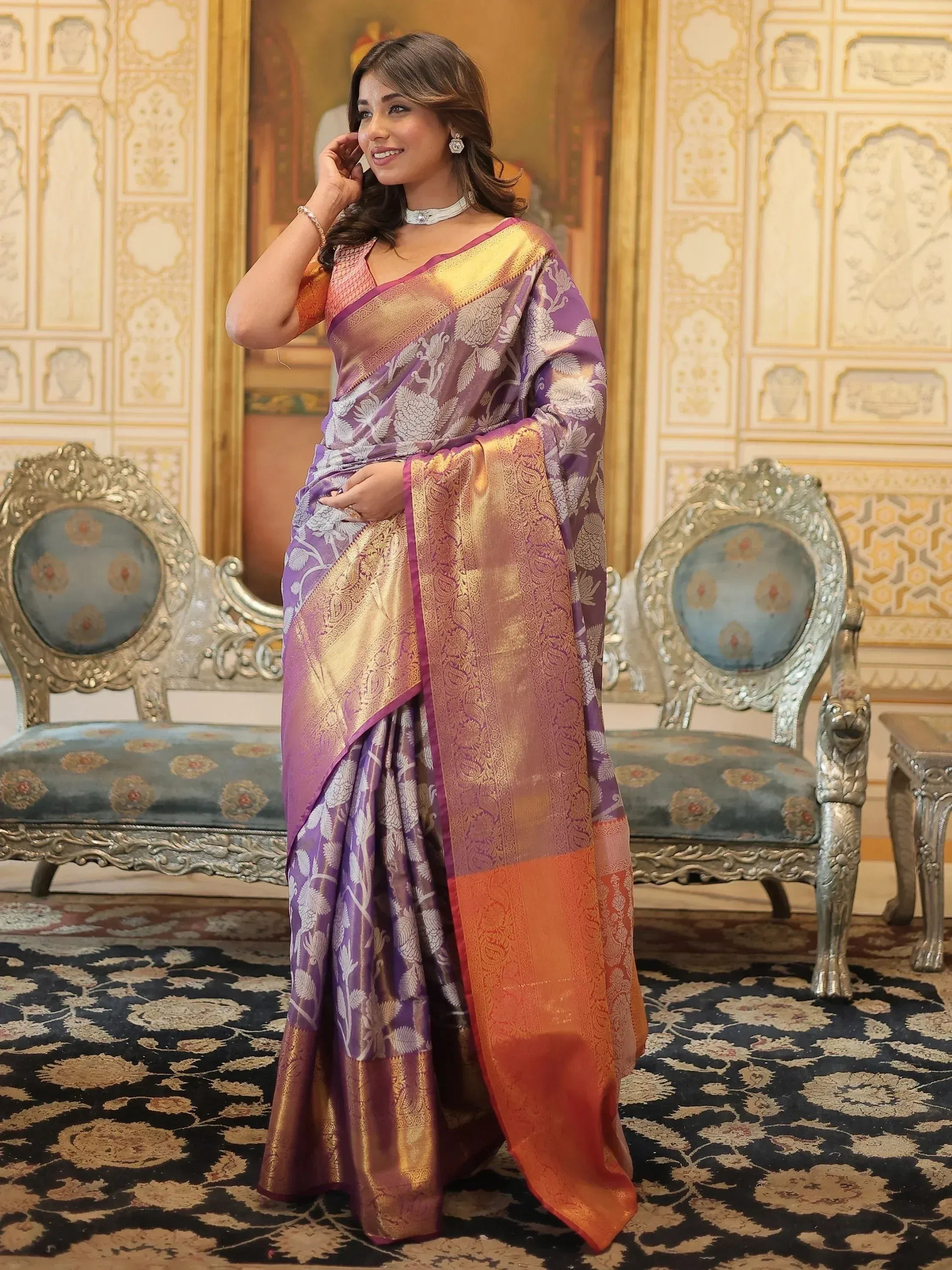 Woman in purple and gold designer saree with floral weave, ethnic wear for festive occasions