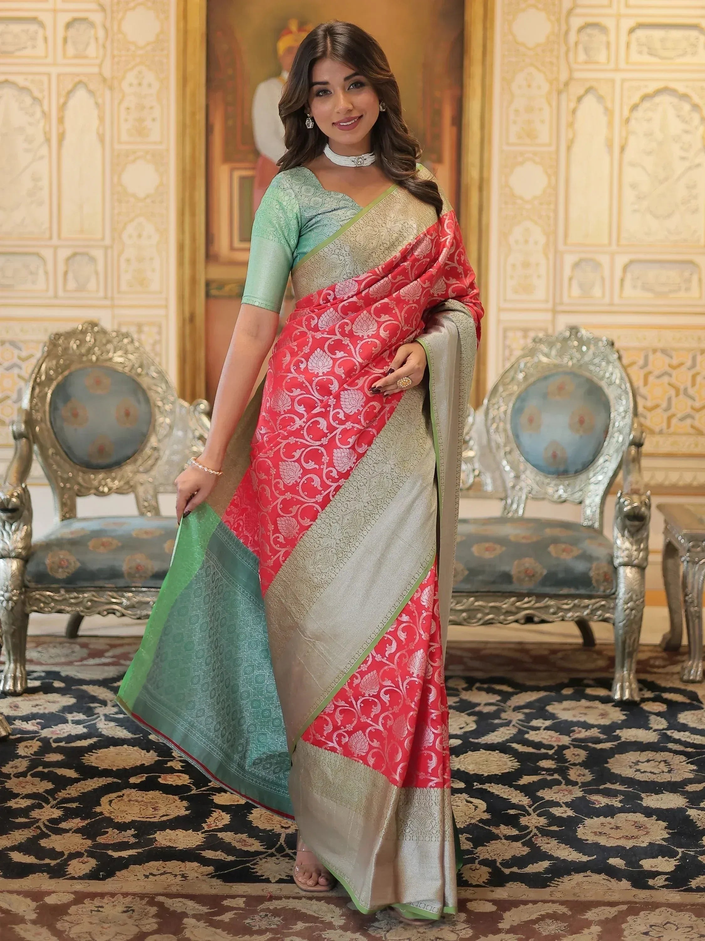 Woman in elegant red and green designer saree with gold embroidery, perfect for Indian ethnic occasions