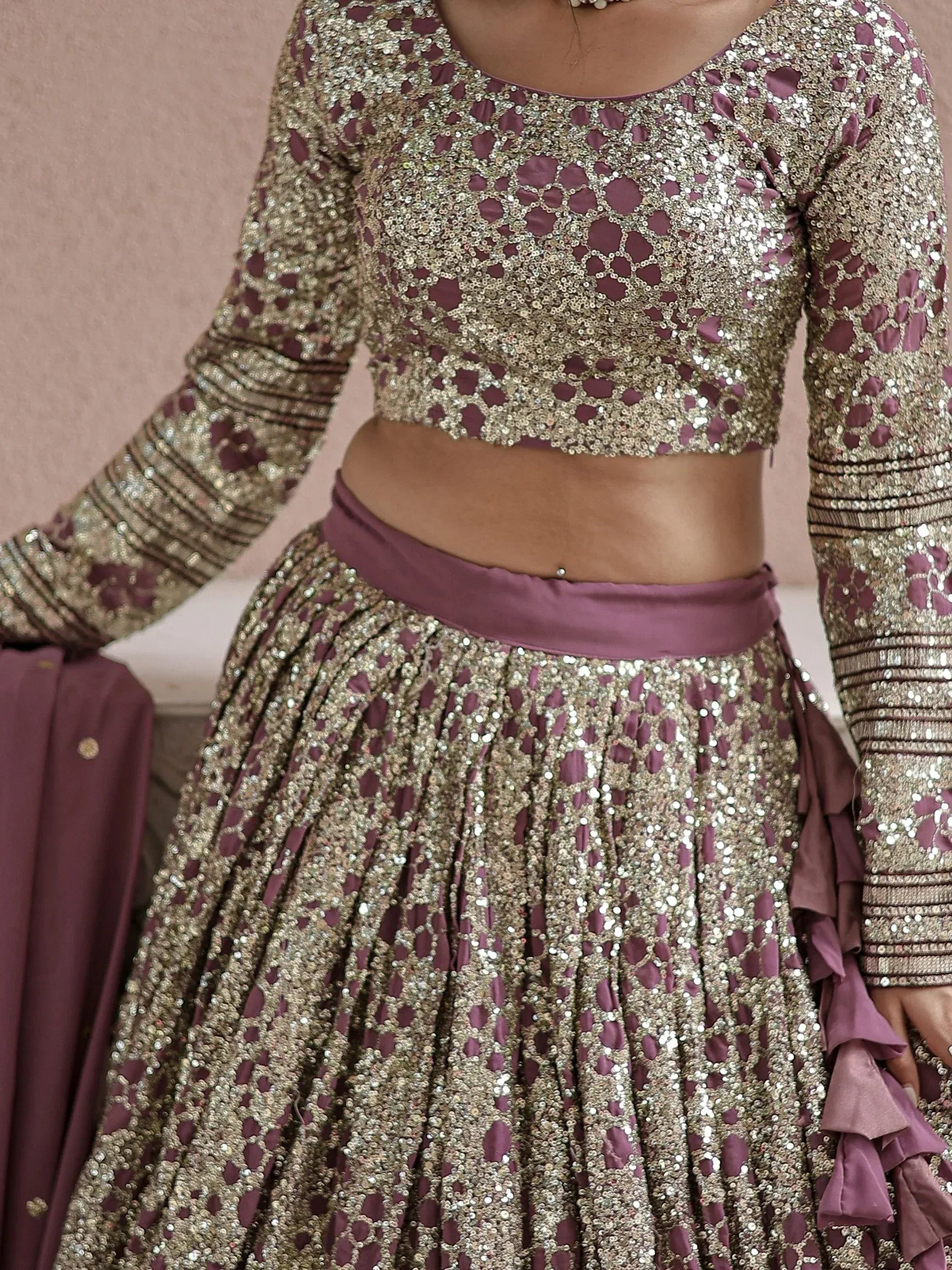 Elegant purple and gold sequin lehenga choli with intricate embroidery, perfect for Indian weddings and festive occasions.