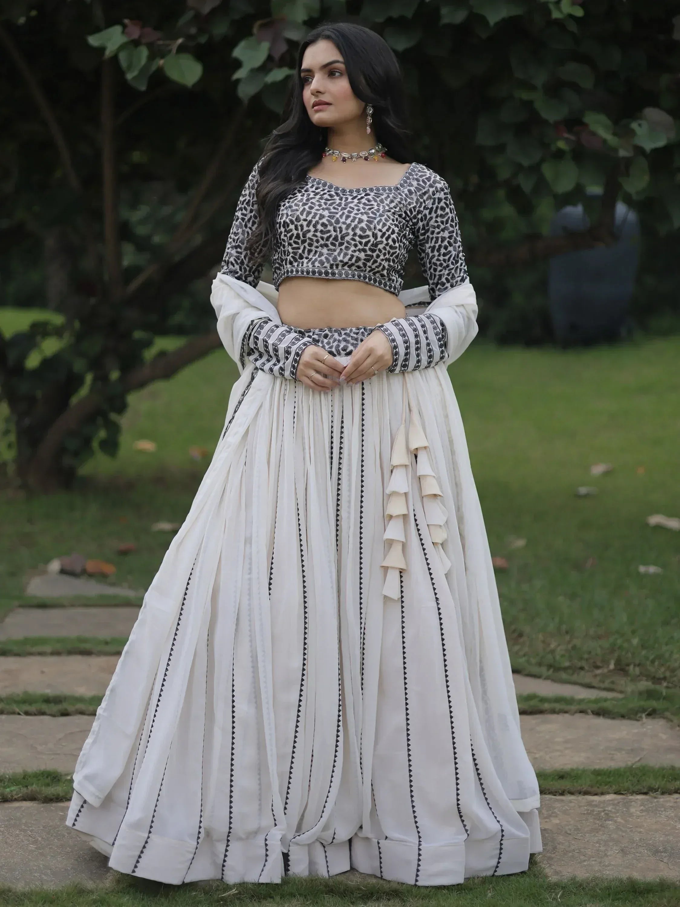 White and black printed lehenga choli with ruffle detailing, perfect for Indian ethnic wear occasions