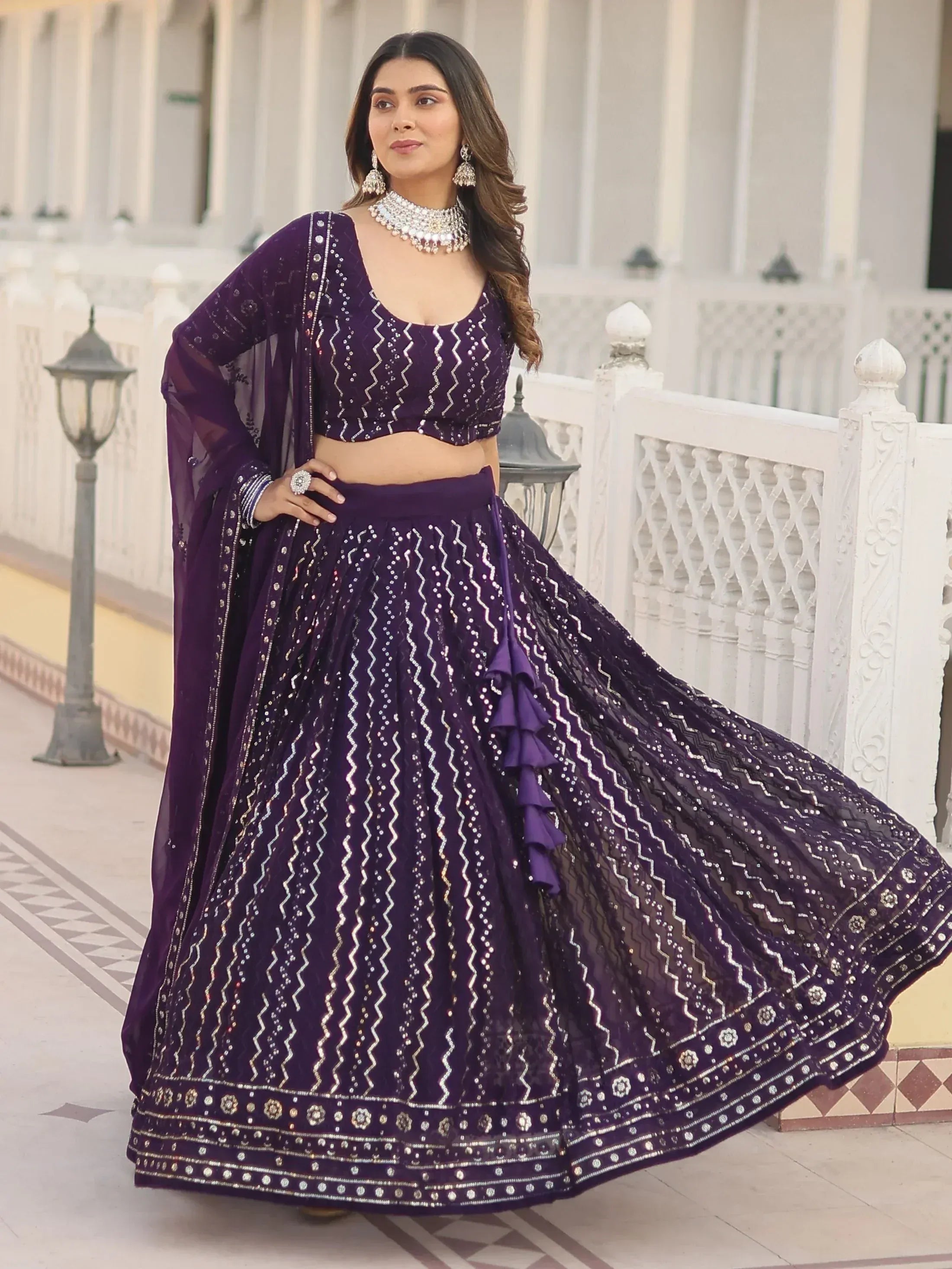 Purple designer lehenga choli with sequin embroidery and ruffle detailing, perfect for Indian ethnic wear occasions.