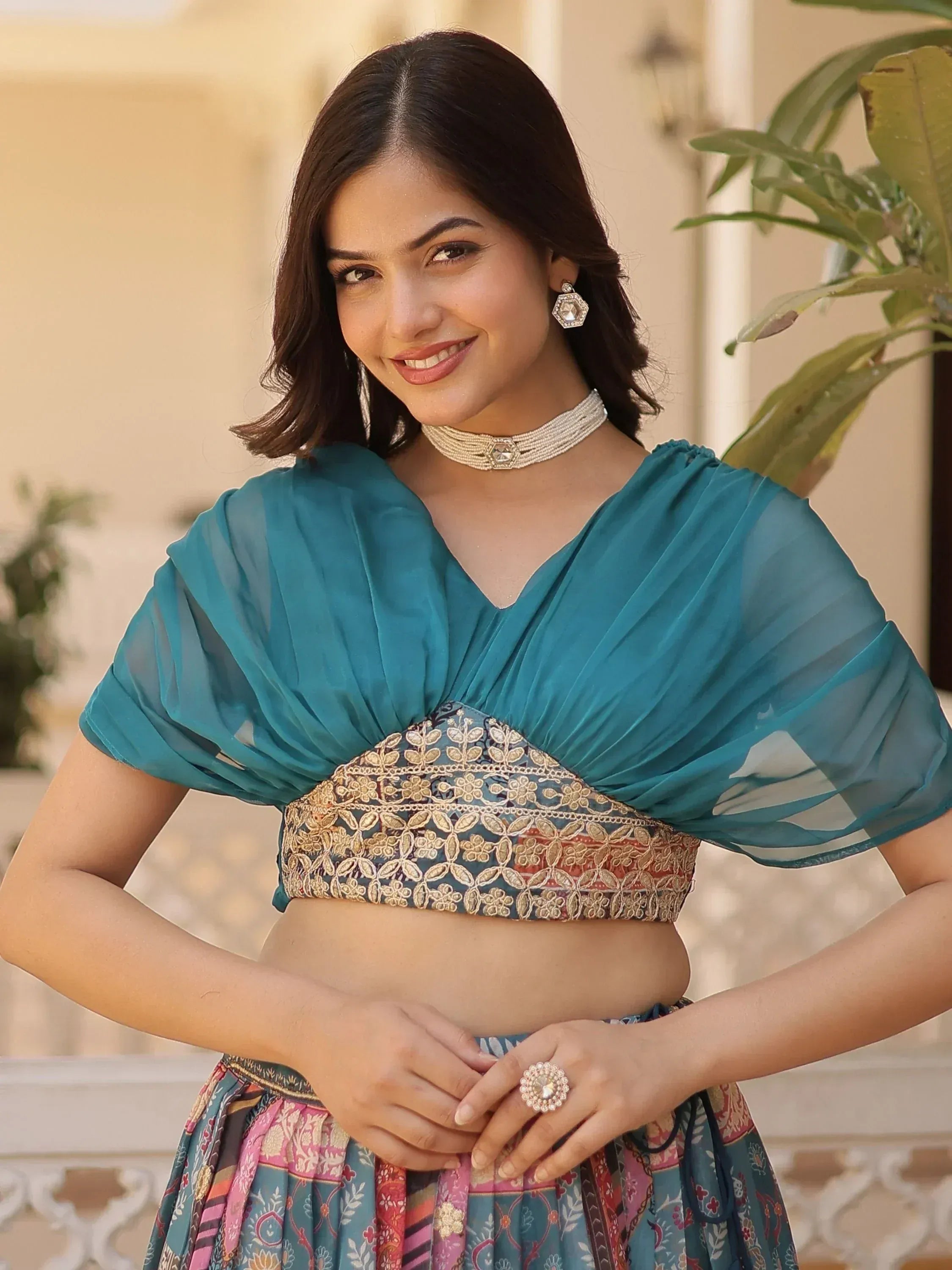 Teal embroidered lehenga choli with sheer cape, perfect for Indian ethnic wear and festive occasions.