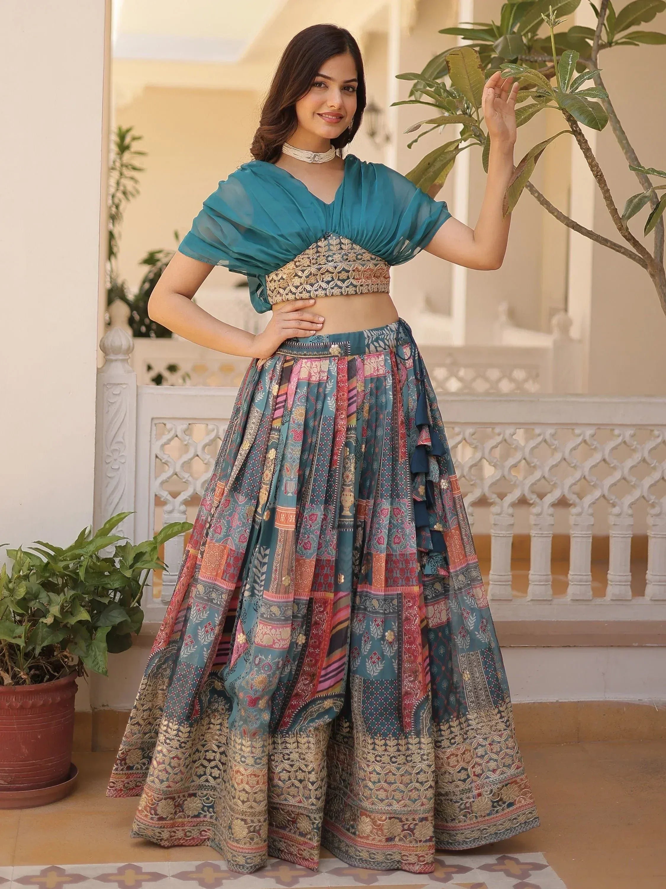 Teal embroidered lehenga choli with patchwork skirt, perfect for Indian ethnic wear events