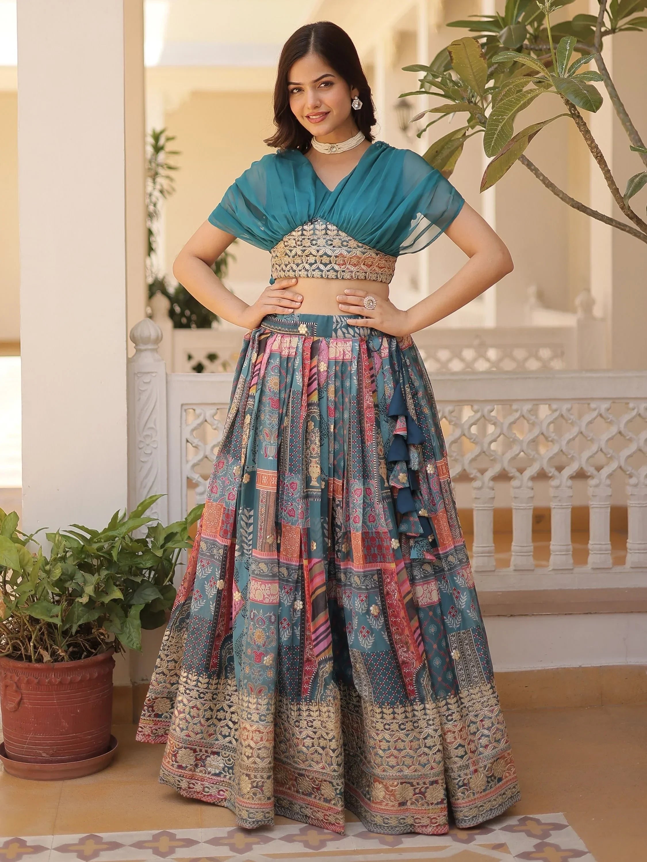 Teal designer lehenga choli with printed skirt and ruffle details, perfect for Indian ethnic wear occasions