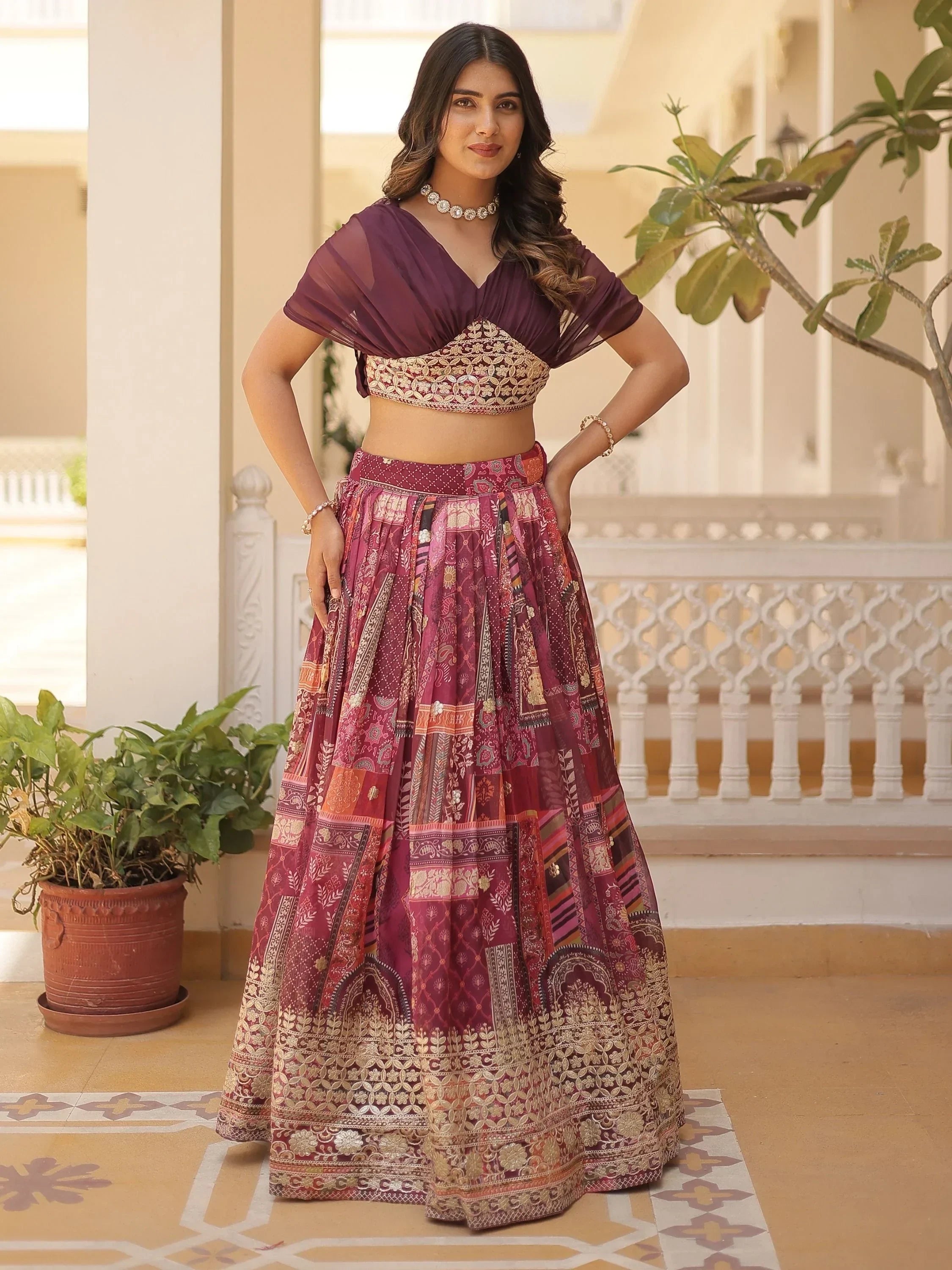 Woman in maroon embroidered lehenga choli with sheer cape, Indian ethnic wear for festive occasions