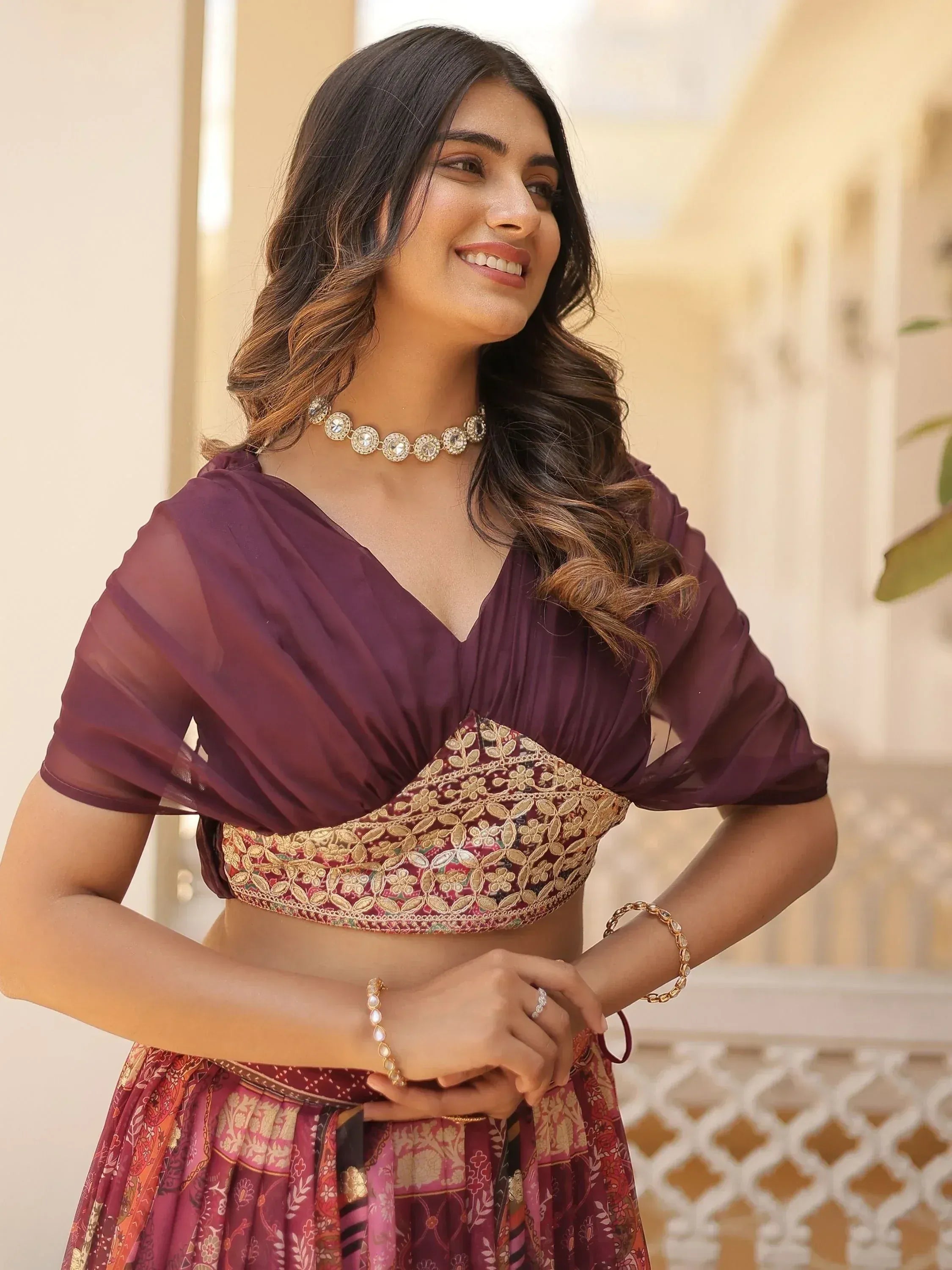 Woman in purple embroidered lehenga choli with gold detailing, perfect for Indian ethnic wear occasions