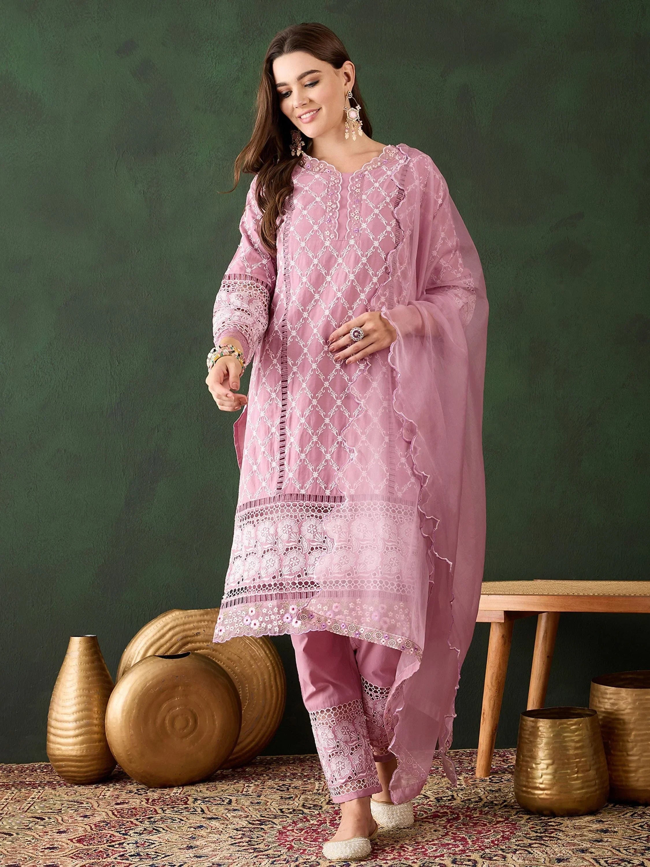 Woman wearing light pink embroidered salwar kameez with dupatta, ethnic Indian outfit
