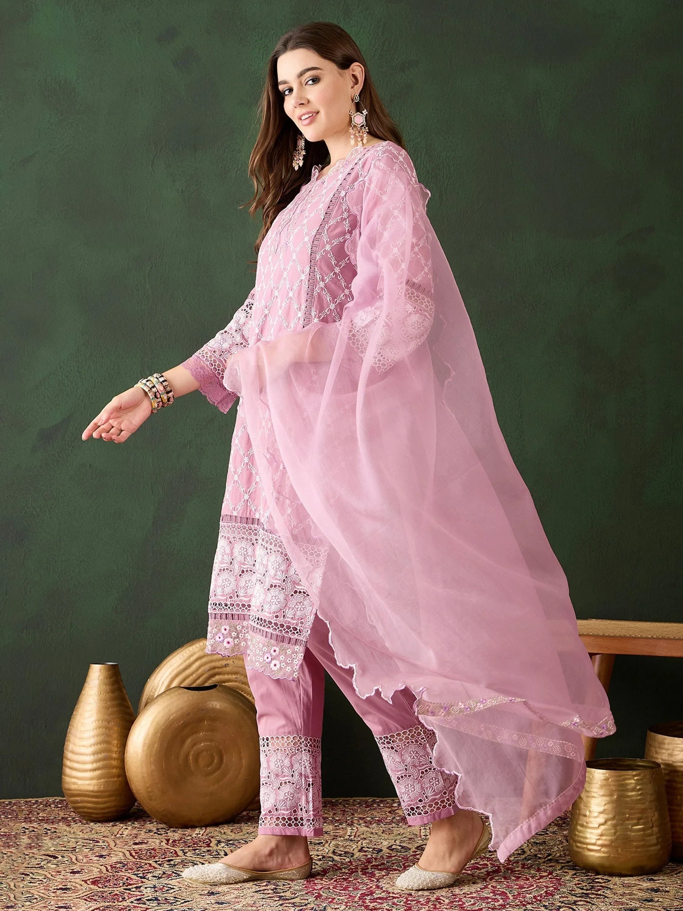 Woman in pastel pink embroidered salwar kameez with dupatta, ethnic Indian wear
