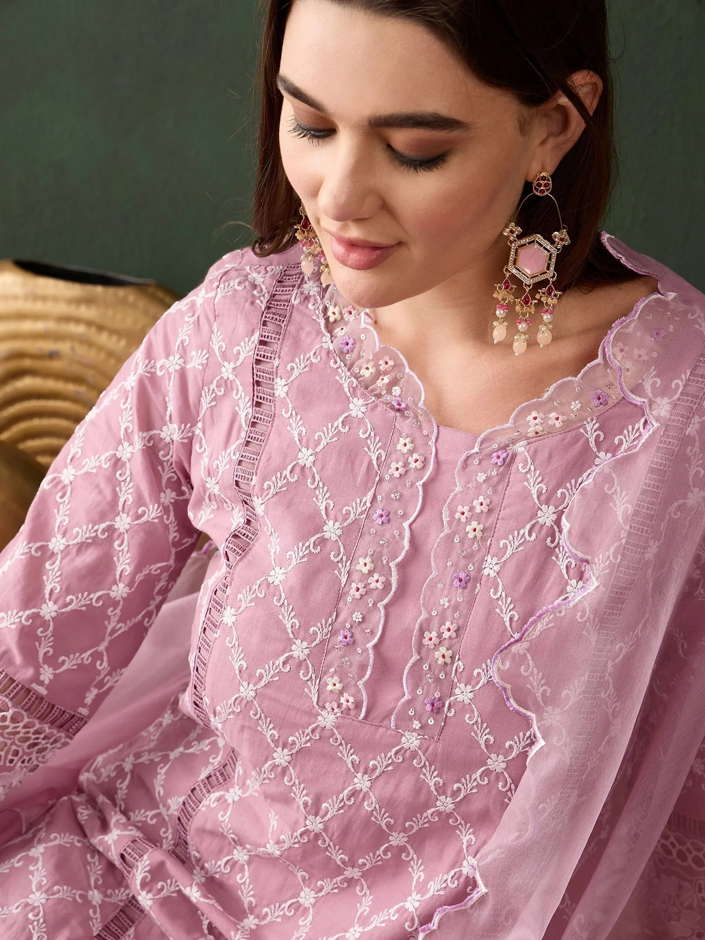 Woman in pink embroidered ethnic kurta with floral details and statement earrings