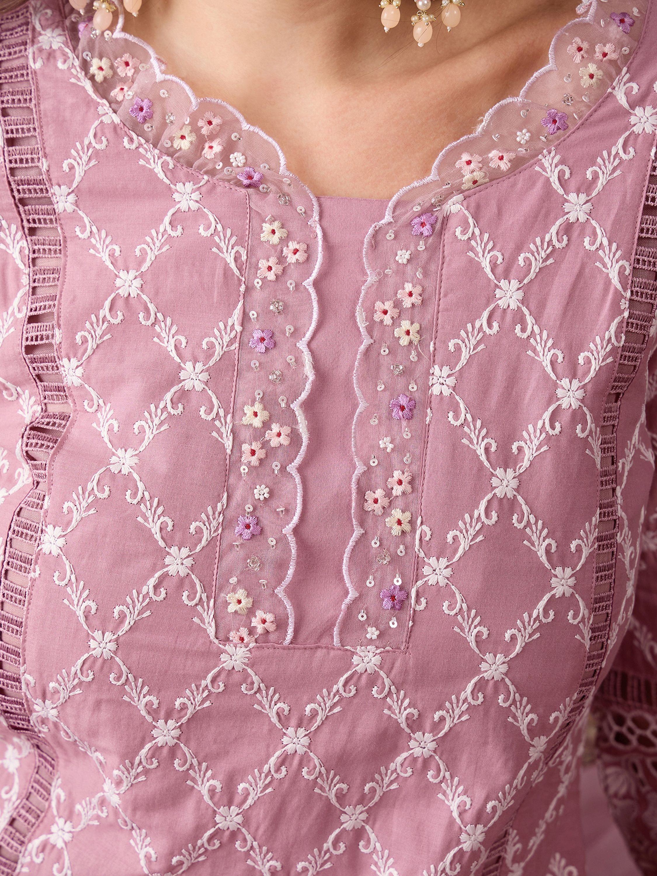 Close-up of mauve embroidered kurti with floral lace detailing and white threadwork pattern