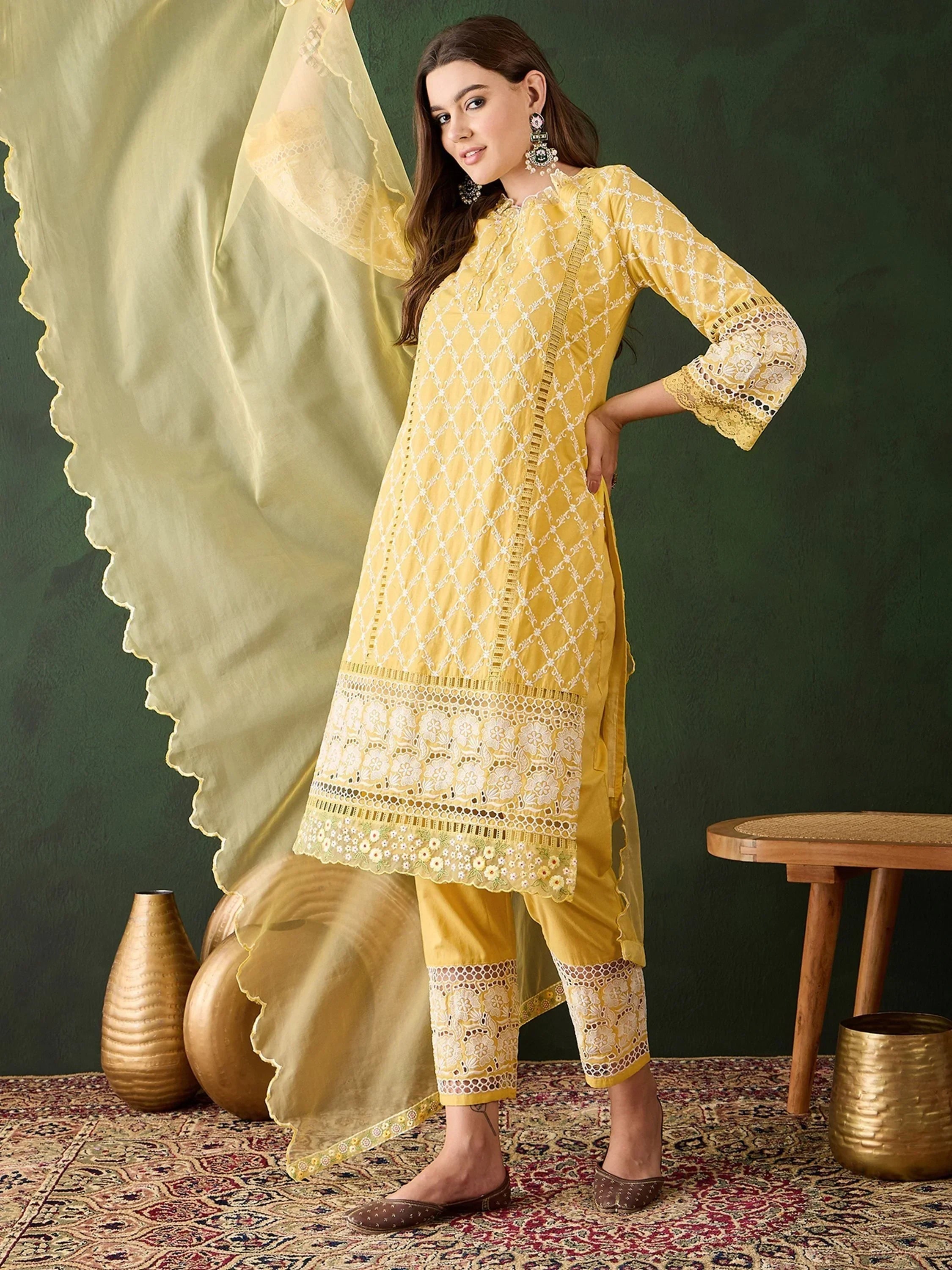 Woman wearing yellow embroidered salwar kameez with dupatta, ethnic Indian outfit