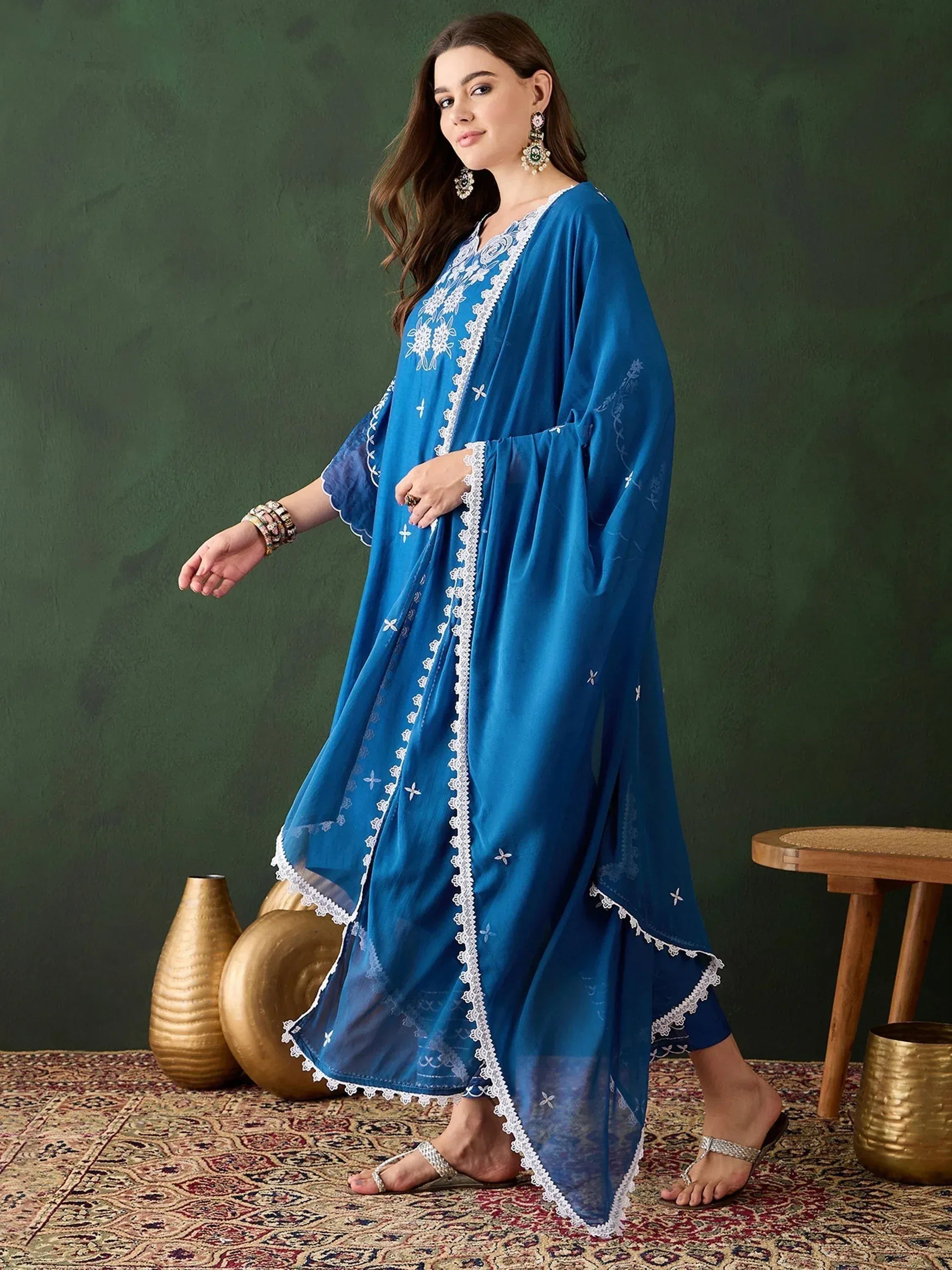 Blue embroidered ethnic gown with white lace detailing, perfect for Indian festive wear