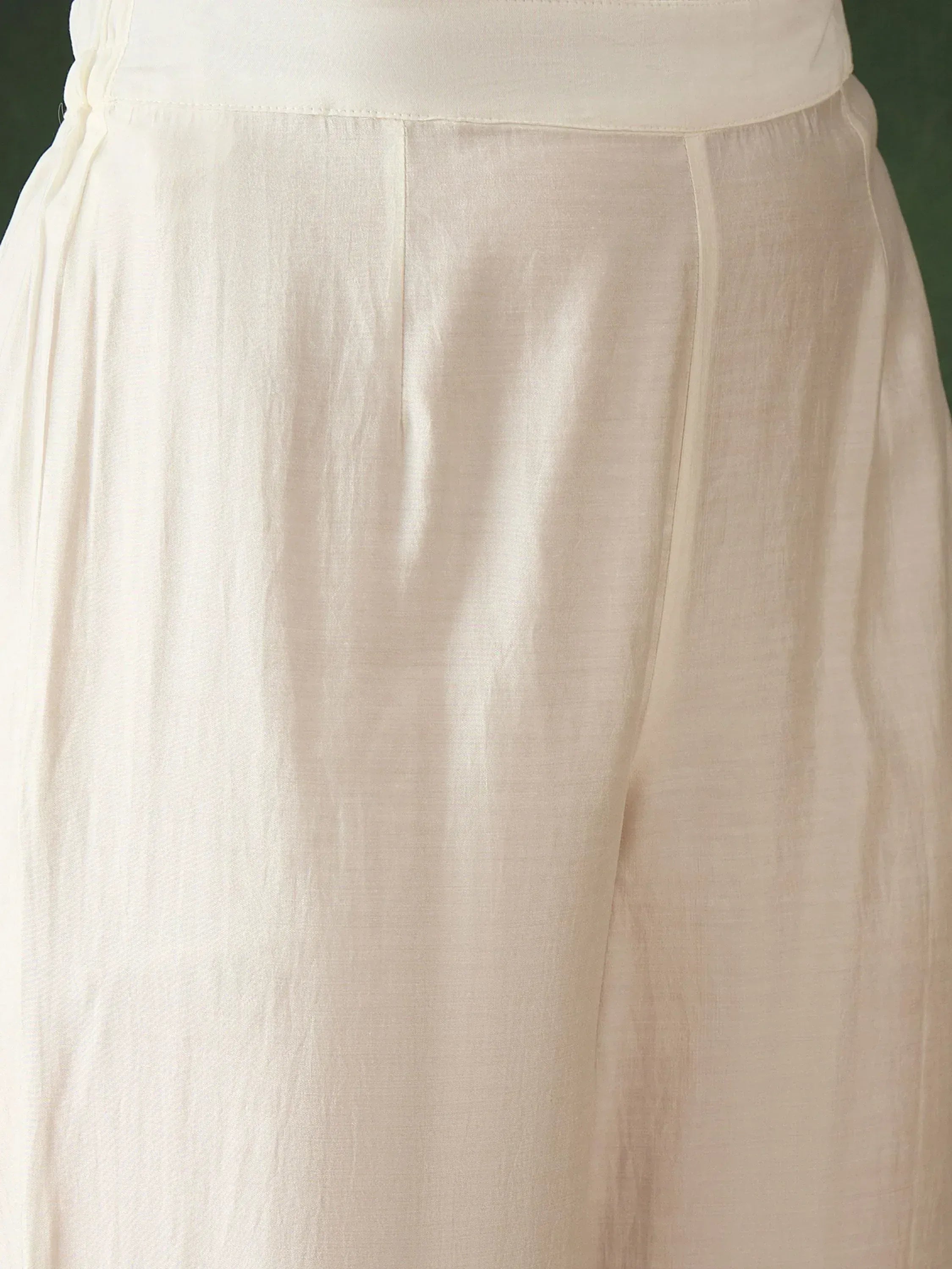Cream ethnic gown with pleated waist detail, soft fabric, elegant Indian wear