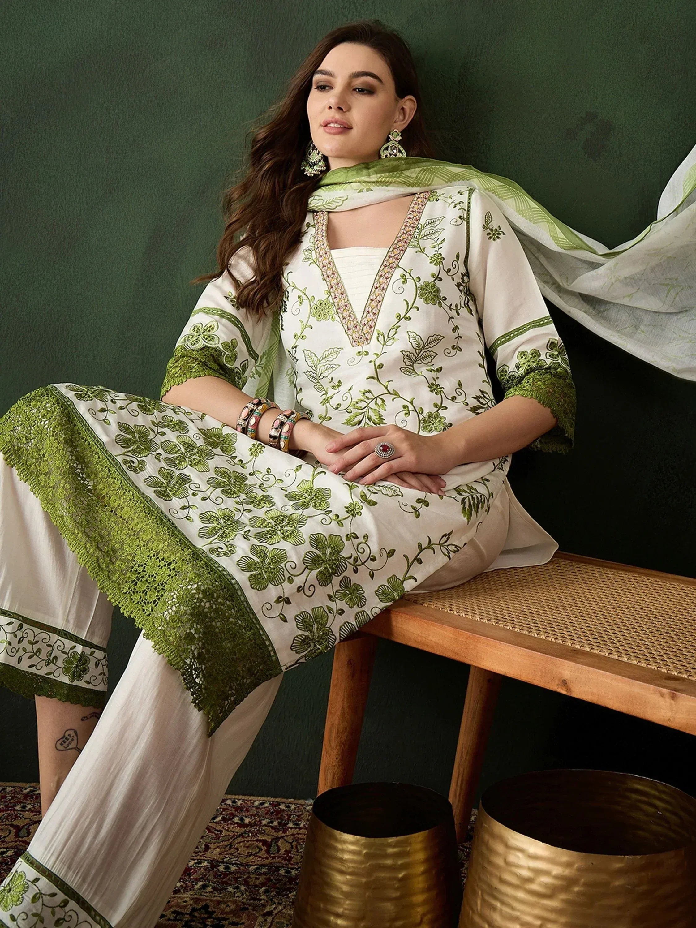 White and green embroidered salwar kameez with floral design, perfect for ethnic wear