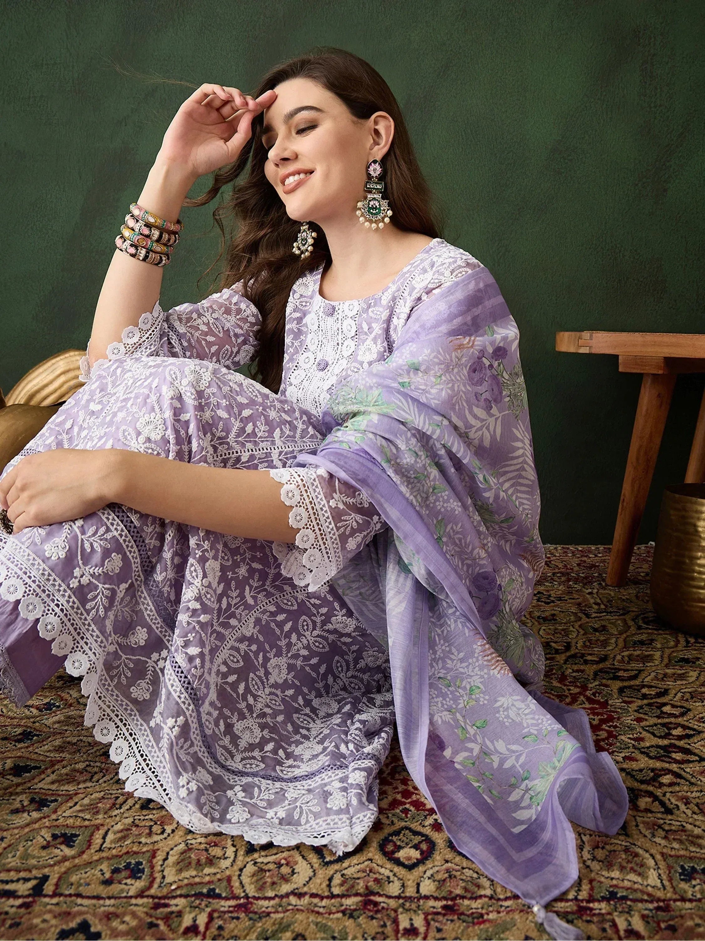 Lavender ethnic salwar kameez with white embroidery and floral dupatta, styled with traditional jewelry.