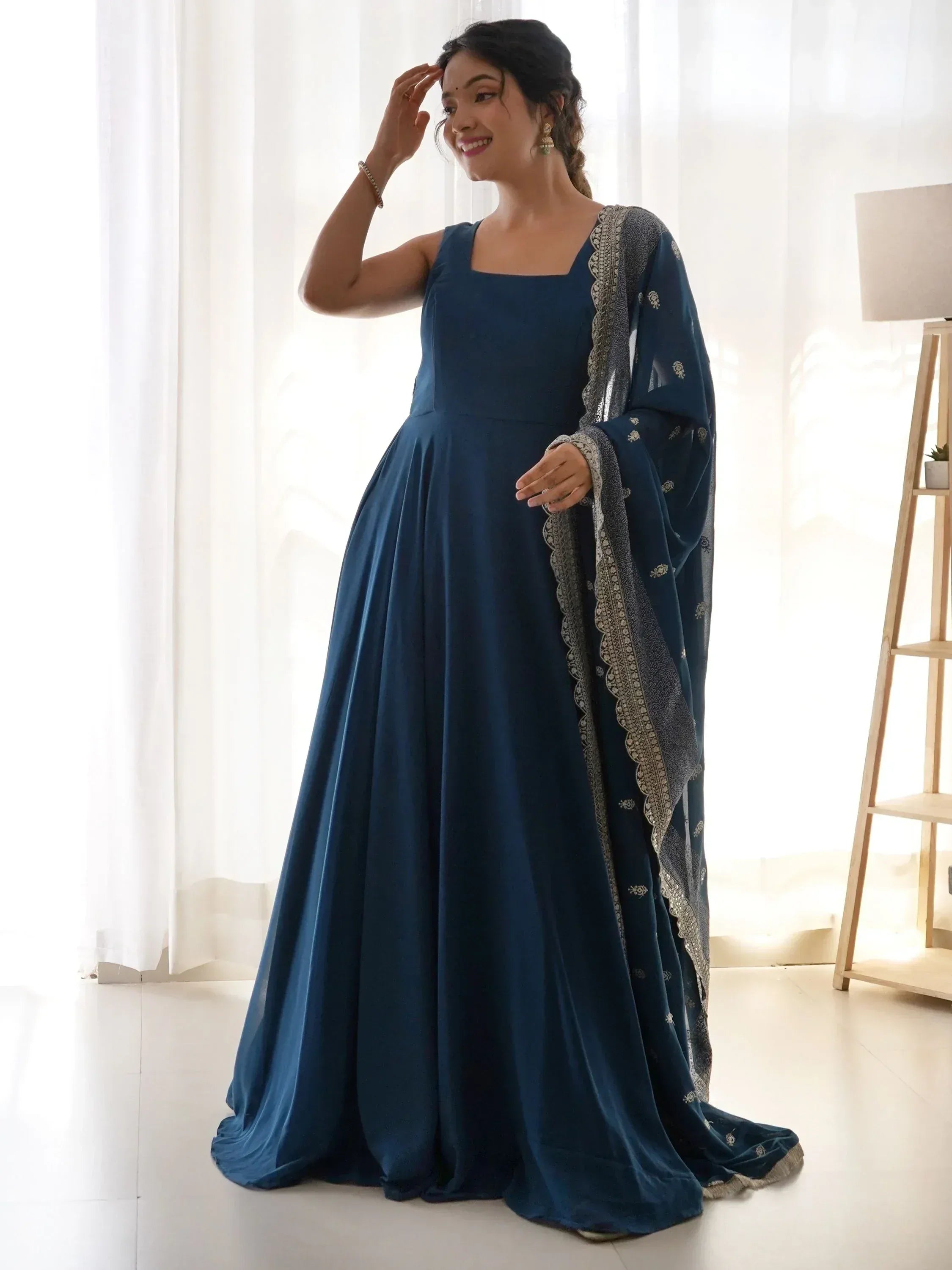 Elegant navy blue ethnic gown with embroidered dupatta, perfect for Indian occasions and festive wear.