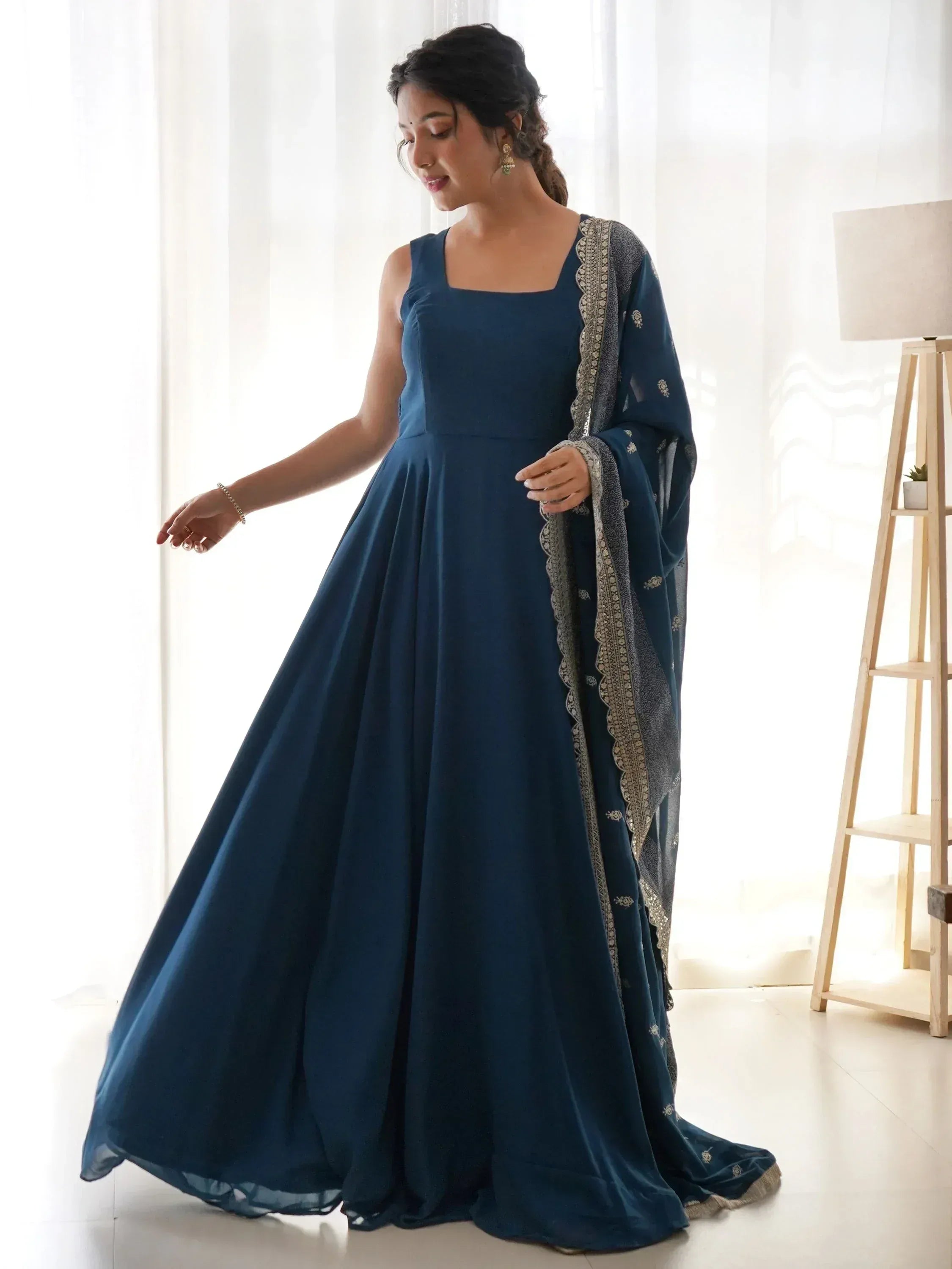 Elegant navy blue ethnic gown with embroidered dupatta, perfect for Indian celebrations and festive occasions.